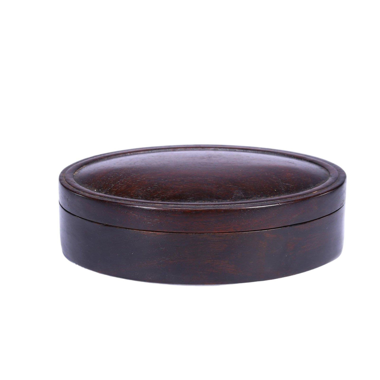 A Chinese Zitan Wood Oval Lidded Box: A Chinese Zitan Wood Oval Lidded Box Crafted from solid zitan wood, this oval lidded box measures 16 cm in length, 10.5 cm in width, 4.5 cm in height, and weighs 330 grams. Its compact, rounded form f