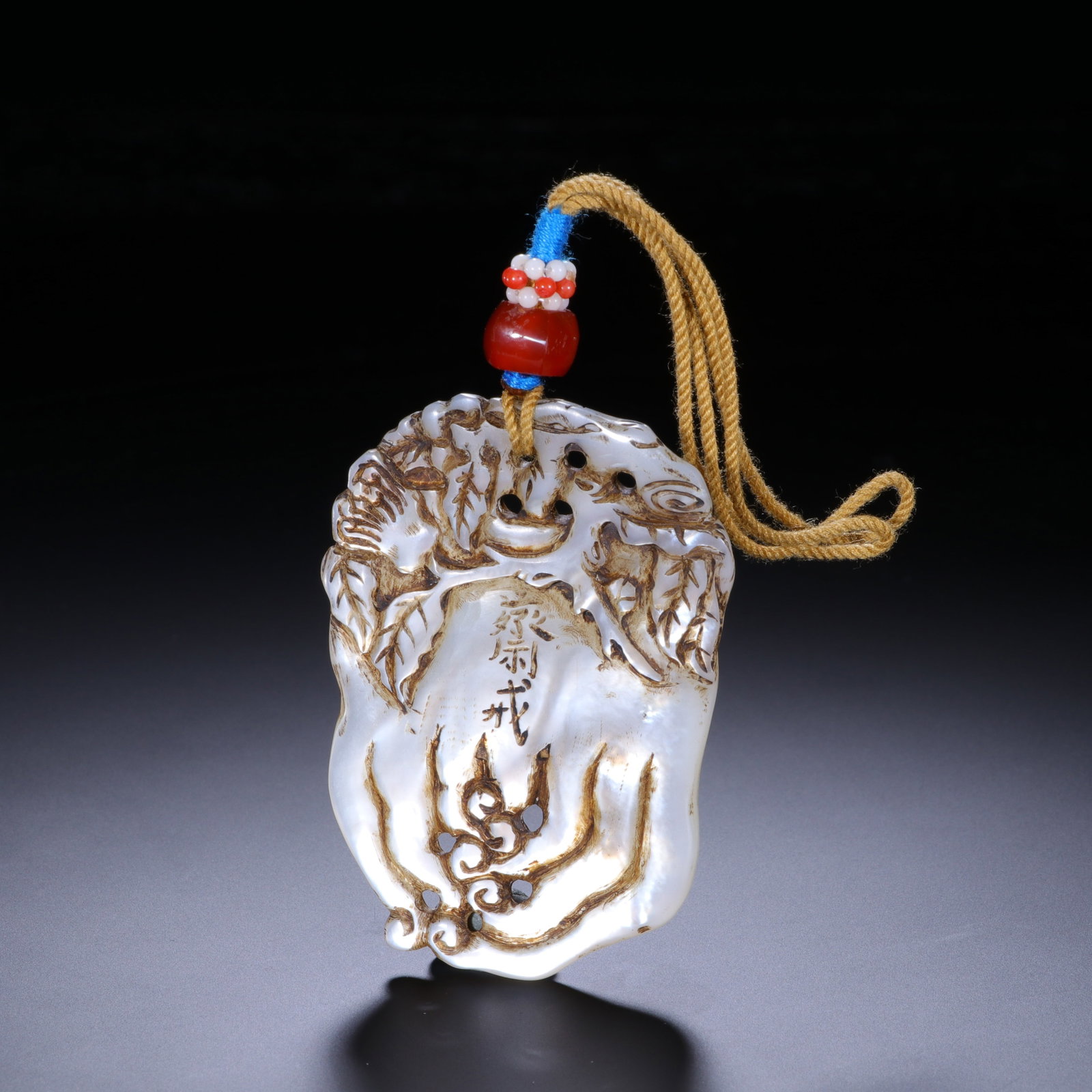 A Chinese Mother-of-Pearl Buddha Hand Abstinence Pendant: A Chinese Mother-of-Pearl Buddha Hand Abstinence Pendant This finely carved pendant, measuring 6 cm in length and 4.2 cm in width, is crafted from iridescent mother-of-pearl. Shaped like a Buddha?s ha