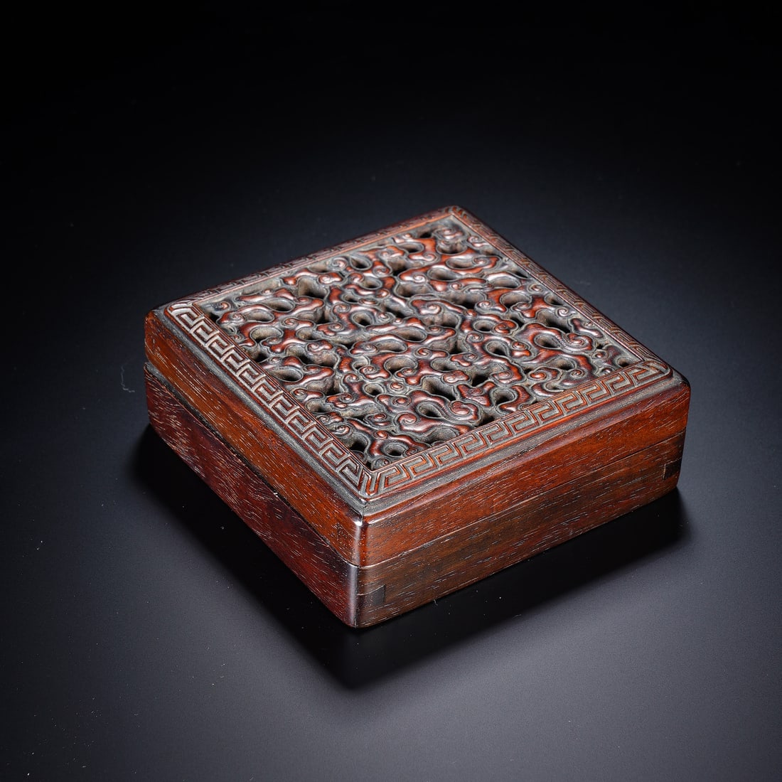 Chinese Zitan Reticulated Carved Square Box: Chinese Zitan Reticulated Carved Square Box This exquisite square box is finely crafted from solid zitan wood, showcasing the material?s rich, deep hue and lustrous patina. The lid features elaborate 