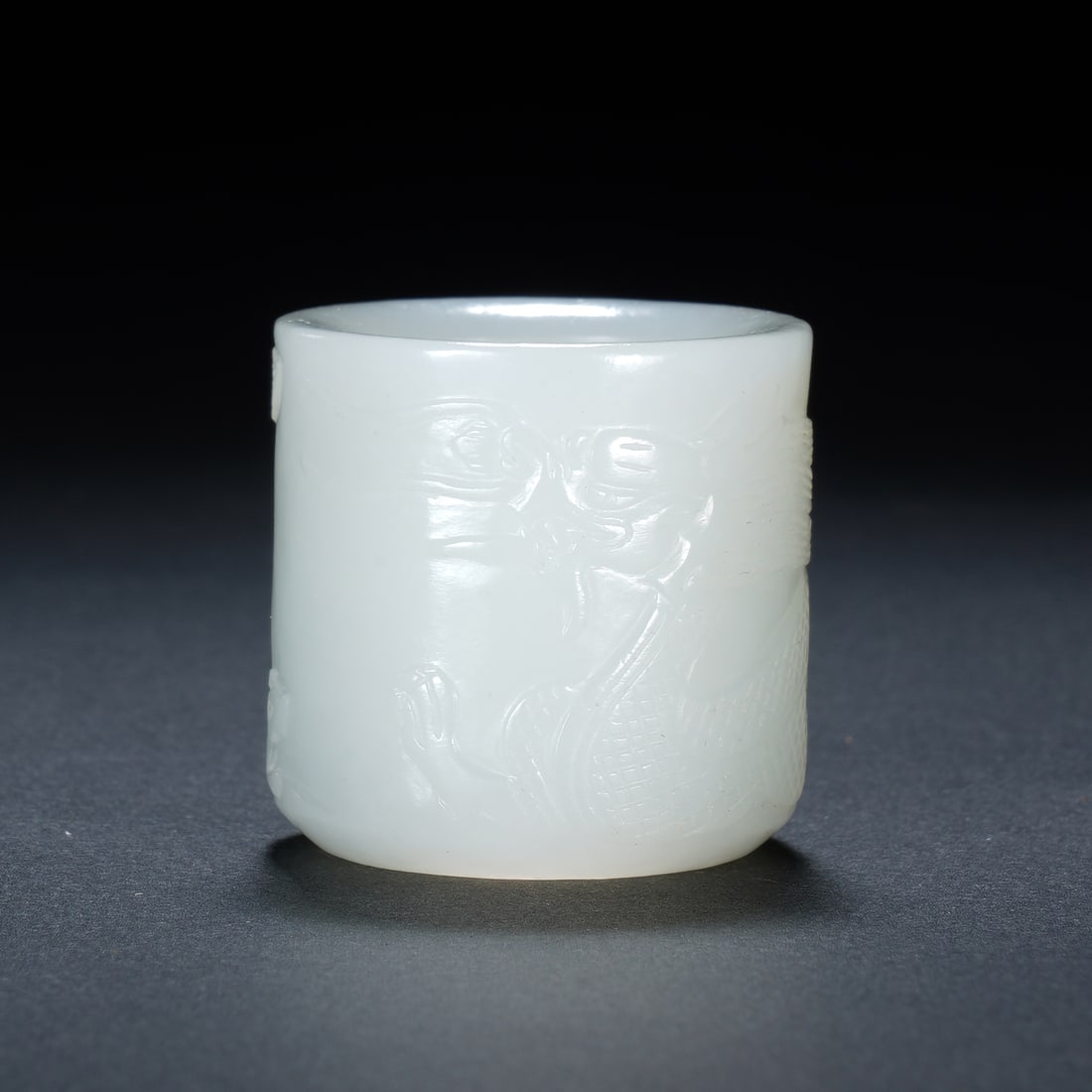 Chinese Hetian White Jade Dragon Archer?s Ring: Chinese Hetian White Jade Dragon Archer?s Ring This finely carved archer?s ring is crafted from a single piece of high-quality Hetian white jade, displaying a smooth, lustrous surface and even milky-w