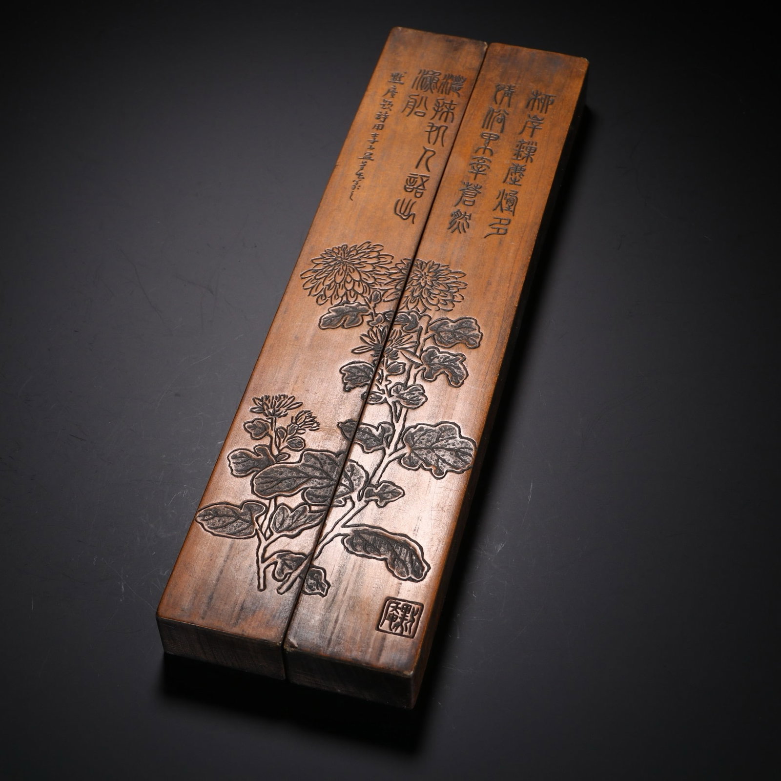 A PAIR OF CHINESE WOOD PAPERWEIGHTS WITH INLAID CHRYSANTHEMUM: A PAIR OF CHINESE WOOD PAPERWEIGHTS WITH INLAID CHRYSANTHEMUM This matching pair of rectangular scholar's paper weights features dark solid wood bases inlaid with lighter veneer panels. The unified de