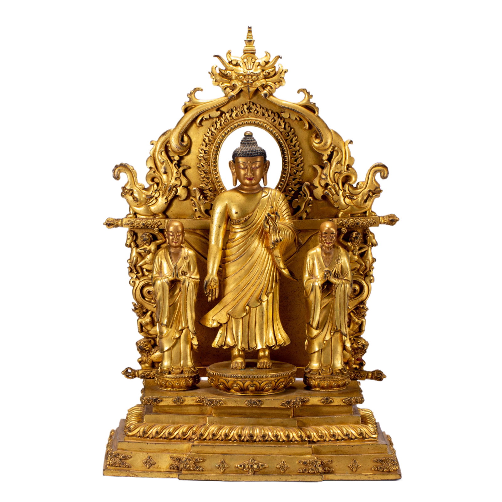 A CHINESE GILT BRONZE BUDDHA TRIAD ALTAR GROUP WITH SHRINE FRAME: A CHINESE GILT BRONZE BUDDHA TRIAD ALTAR GROUP WITH SHRINE FRAME This complete devotional ensemble is fully cast copper alloy with rich uniform gilding, featuring a central standing Buddha flanked by 