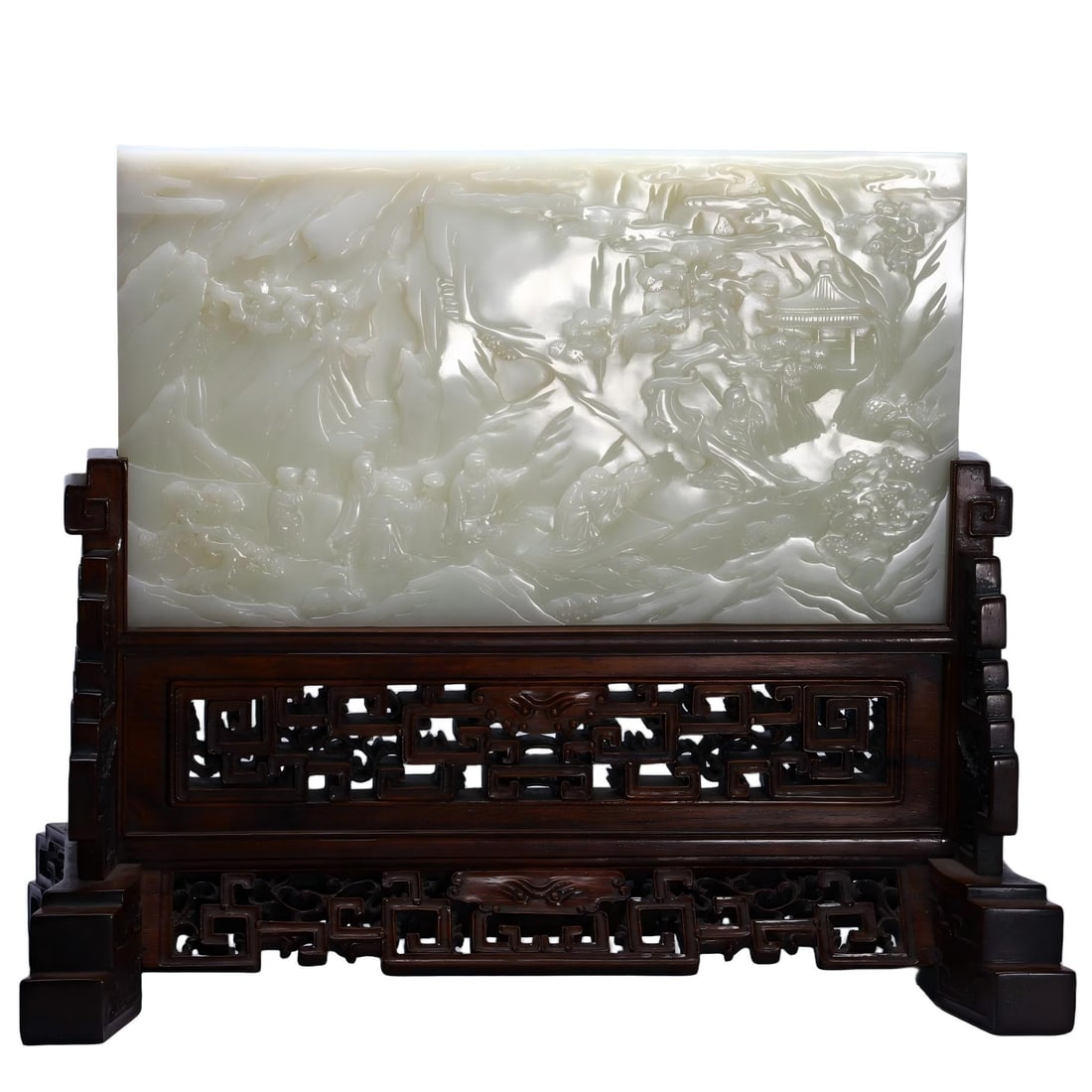 A CHINESE HETIAN JADE LANDSCAPE TABLE SCREEN: A CHINESE HETIAN JADE LANDSCAPE TABLE SCREEN A rectangular plaque carved from smooth pale Hetian nephrite jade, fully decorated in layered relief depicting an immersive mountain landscape with rugged 