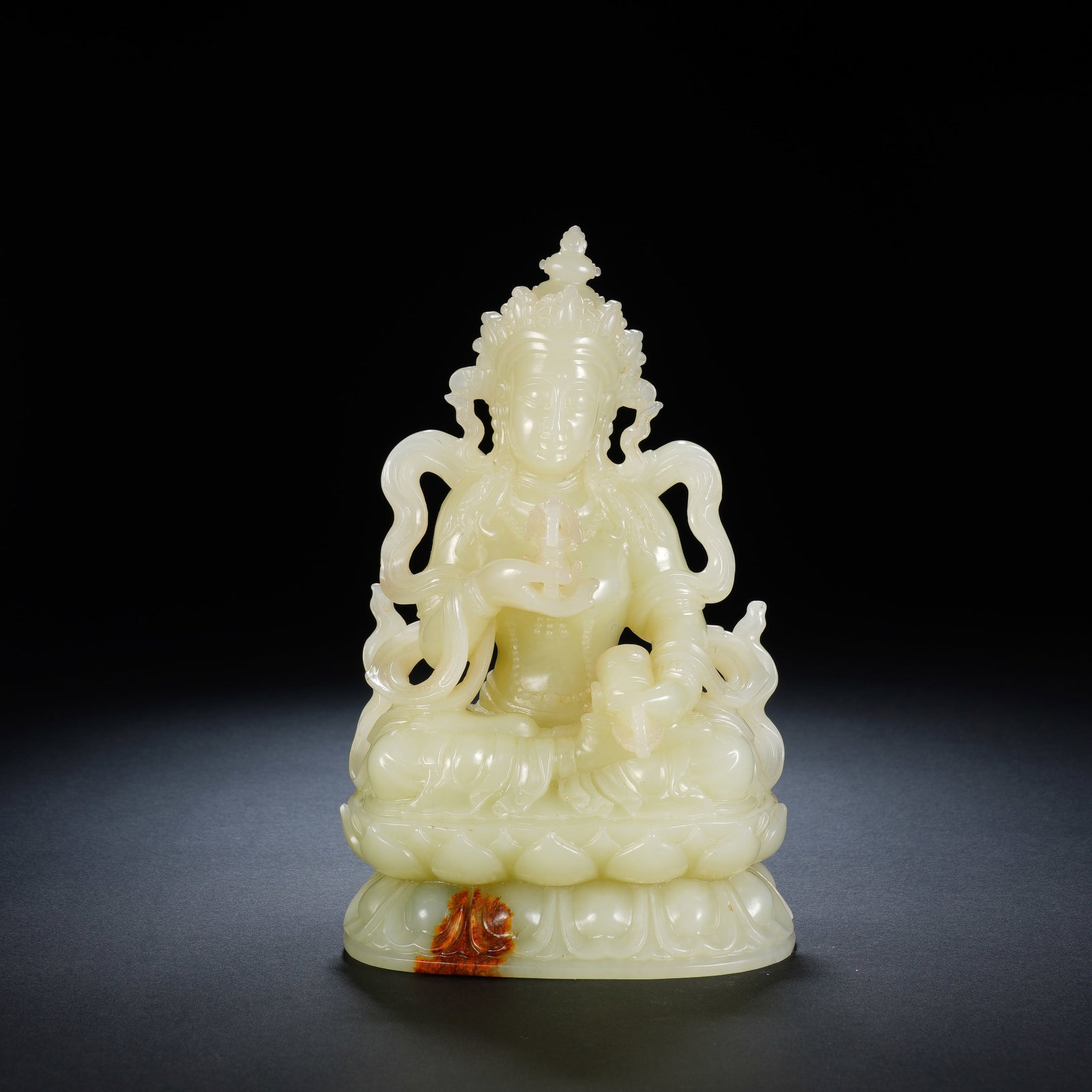 A CHINESE WHITE JADE AMITAYUS BUDDHA WITH RUSSET SKIN: A CHINESE WHITE JADE AMITAYUS BUDDHA WITH RUSSET SKIN This seated Amitayus carving measures 9cm ? 6cm ? 16cm and weighs 787 grams, fashioned from fine pale white nephrite jade retaining a patch of nat