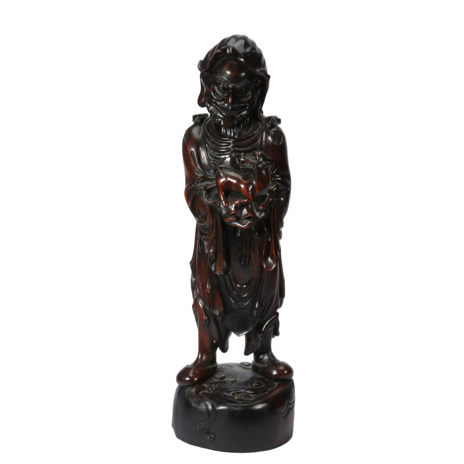 A CHINESE HARDWOOD CARVED IMMORTAL STANDING FIGURE: A CHINESE HARDWOOD CARVED IMMORTAL STANDING FIGURE This tall standing statue is fully carved from dense dark hardwood with a glossy deep reddish-brown patina. The robed immortal figure features sharpl