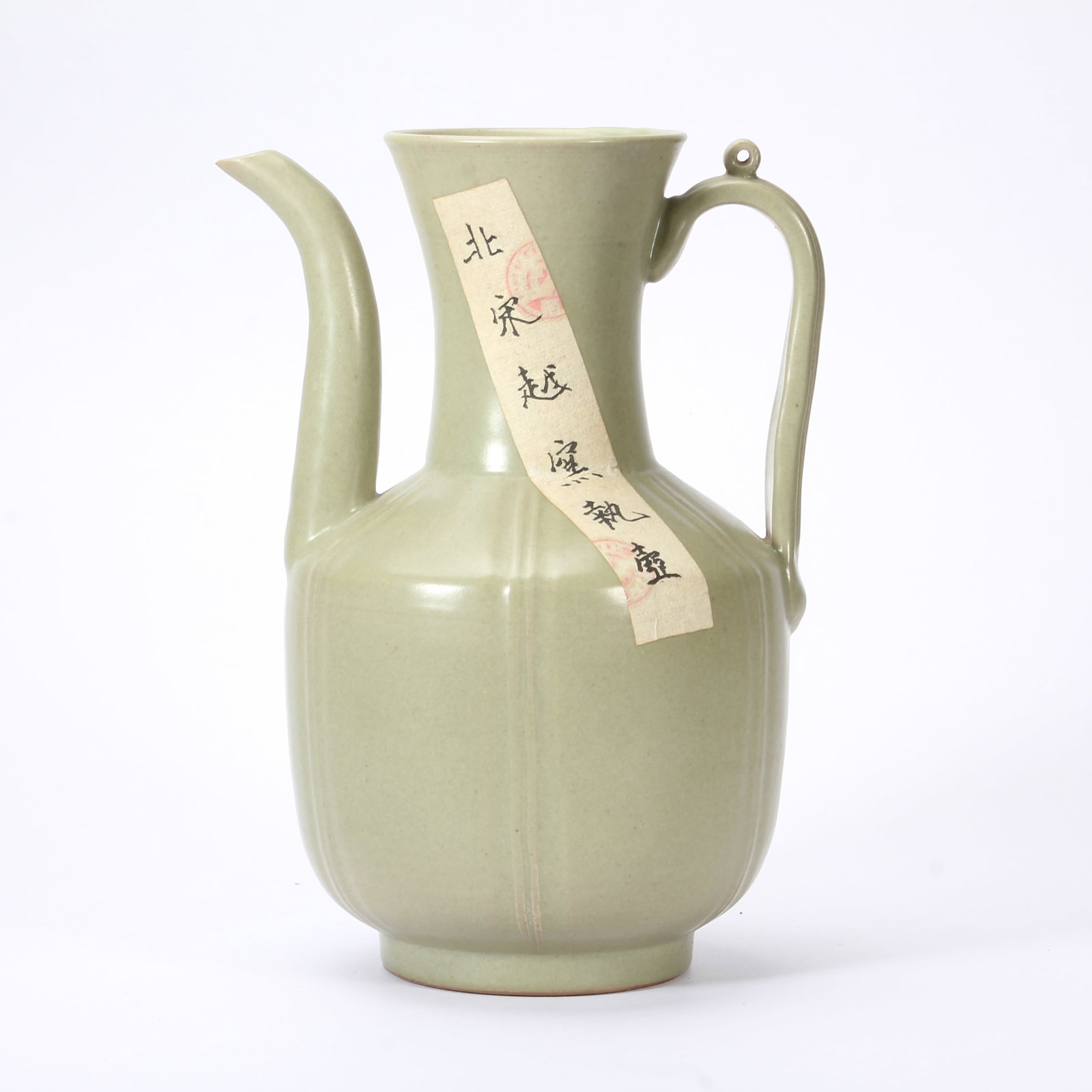 A CHINESE YUE-TYPE CELADON LOBED EWER: A CHINESE YUE-TYPE CELADON LOBED EWER This elegant wine ewer is uniformly coated in soft matte celadon glaze of muted olive tone, covering every surface from flared trumpet mouth down to short circula