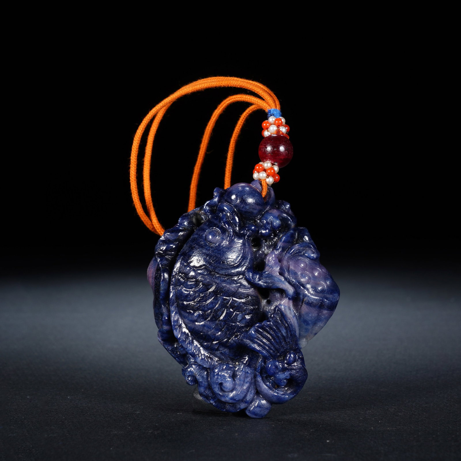 A CHINESE SODALITE FISH CARVED PENDANT: A CHINESE SODALITE FISH CARVED PENDANT This carved hardstone pendant measures 6 cm wide, 5 cm tall and 2.5 cm thick, weighing 110 grams. Fashioned from deep blue sodalite with natural tonal mottling, 