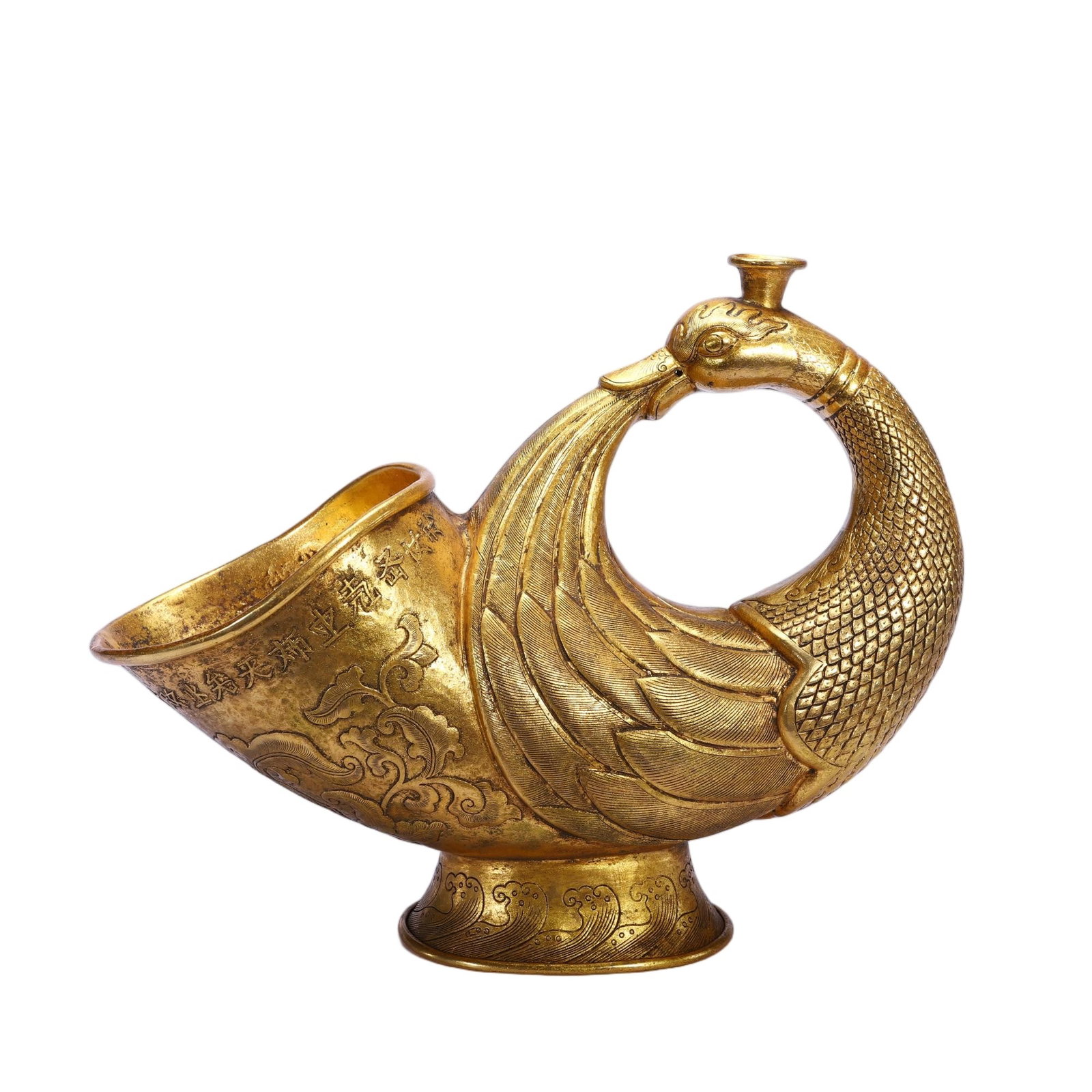 A CHINESE GILT BRONZE PHOENIX FORM POURING VESSEL: A CHINESE GILT BRONZE PHOENIX FORM POURING VESSEL Fashioned entirely from gilt bronze, this libation vessel takes the elegant silhouette of a phoenix whose curved neck loops to form a built-in handle.