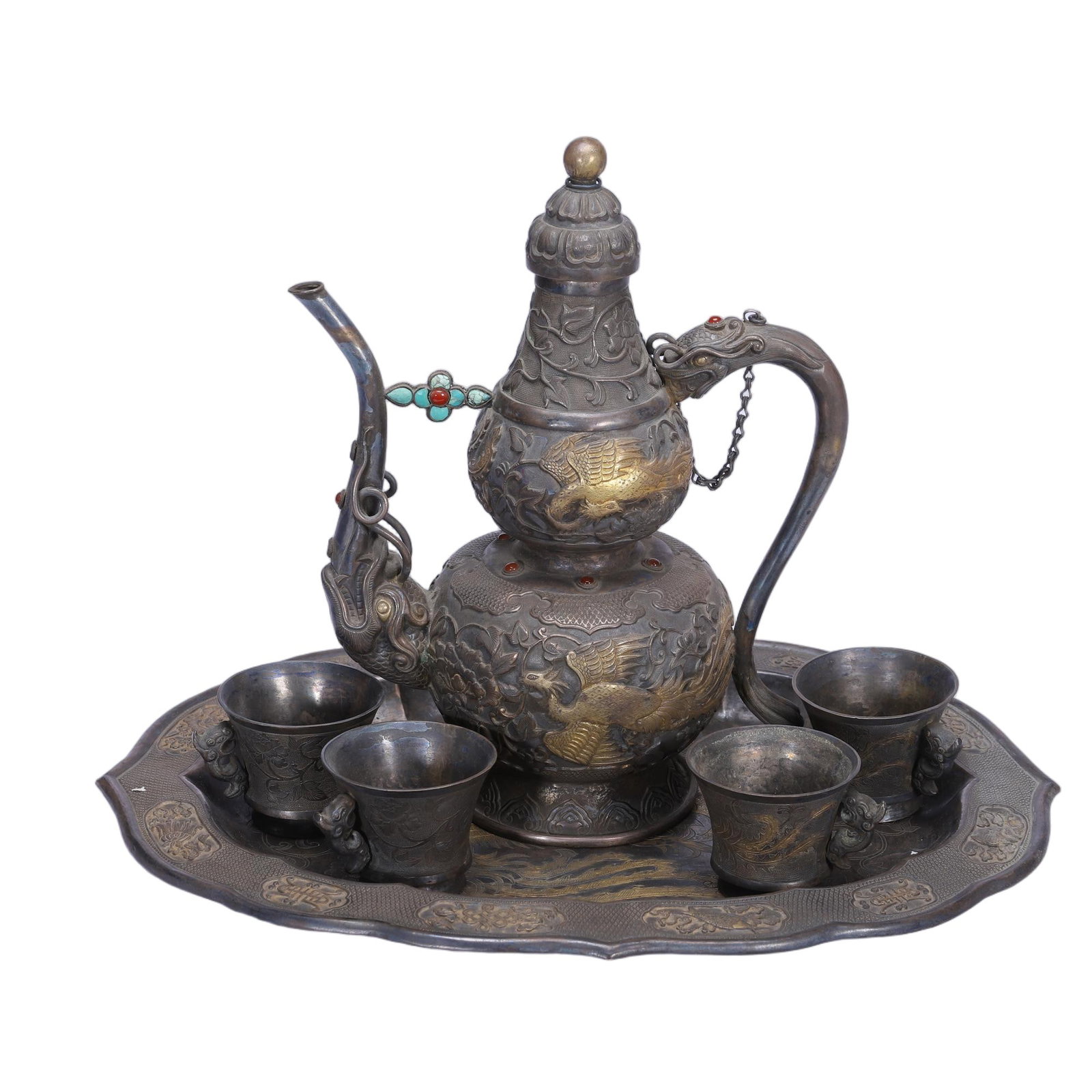 A CHINESE GEM-SET SILVER PHOENIX WINE SUITE: A CHINESE GEM-SET SILVER PHOENIX WINE SUITE This complete vintage silver wine set consists of a double-gourd ewer, four matching cups and a scalloped lotus tray, unified by repouss? gilded phoenix ami