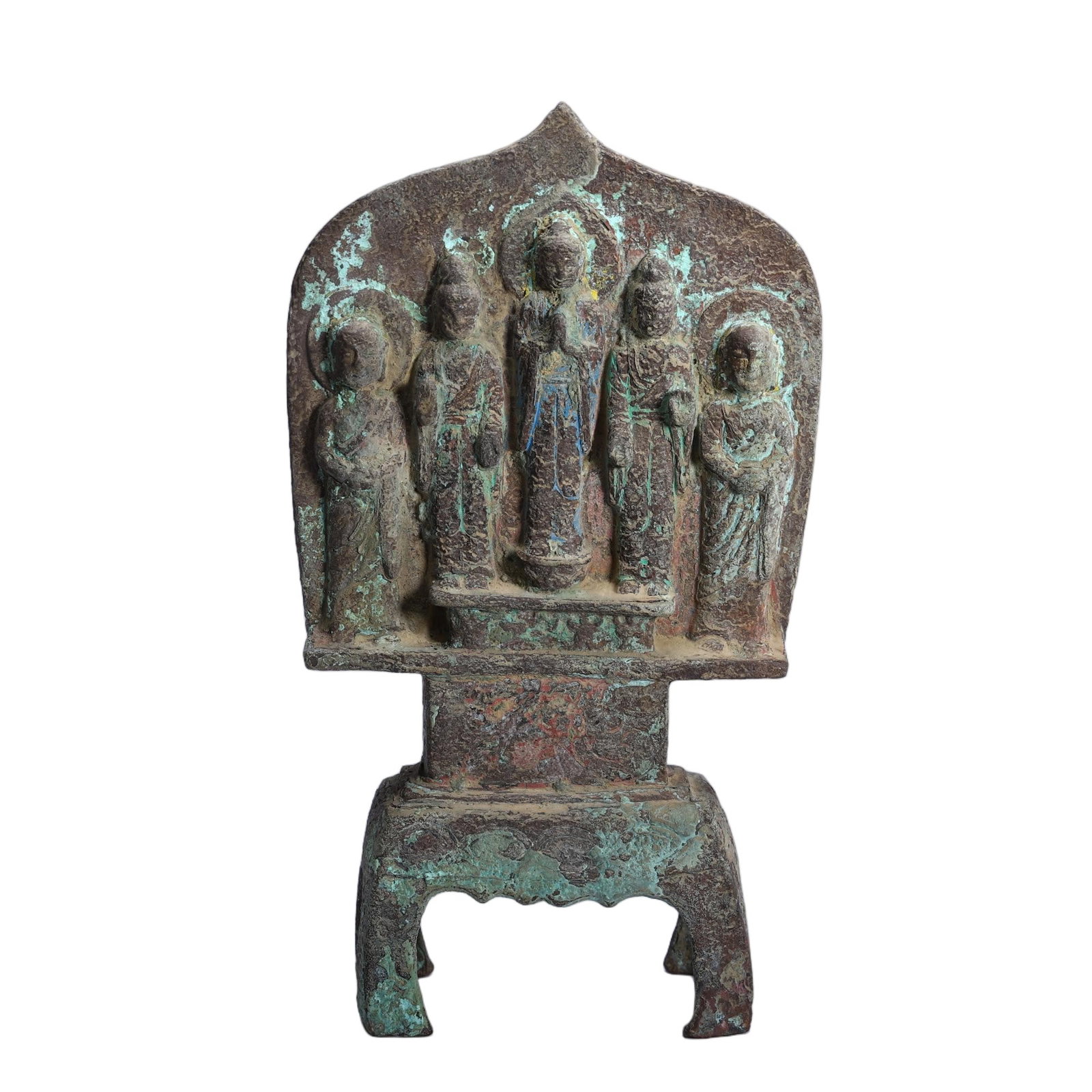 A CHINESE BRONZE FIVE-FIGURE BUDDHIST STELE: A CHINESE BRONZE FIVE-FIGURE BUDDHIST STELE Cast in bronze, this votive stele features a tall pointed flame-shaped mandorla housing a central standing Buddha flanked by four attendant disciples in lay