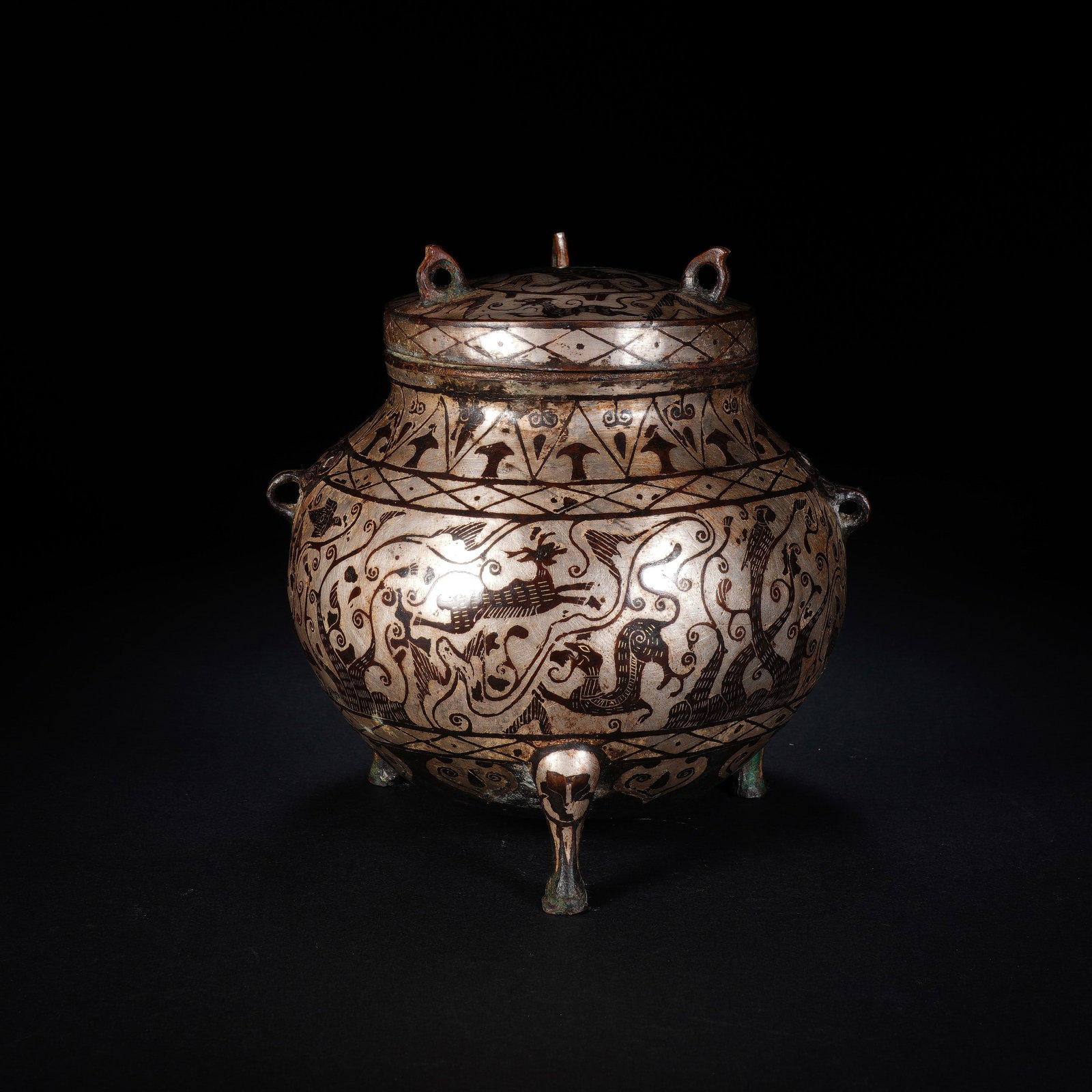 A CHINESE SILVER-INLAID BRONZE CENSER WITH COVER: A CHINESE SILVER-INLAID BRONZE CENSER WITH COVER This lidded bronze tripod censer measures 12 cm tall and 14.5 cm across, weighing 1572 grams. The bulbous vessel body, domed lid and three tapering bea