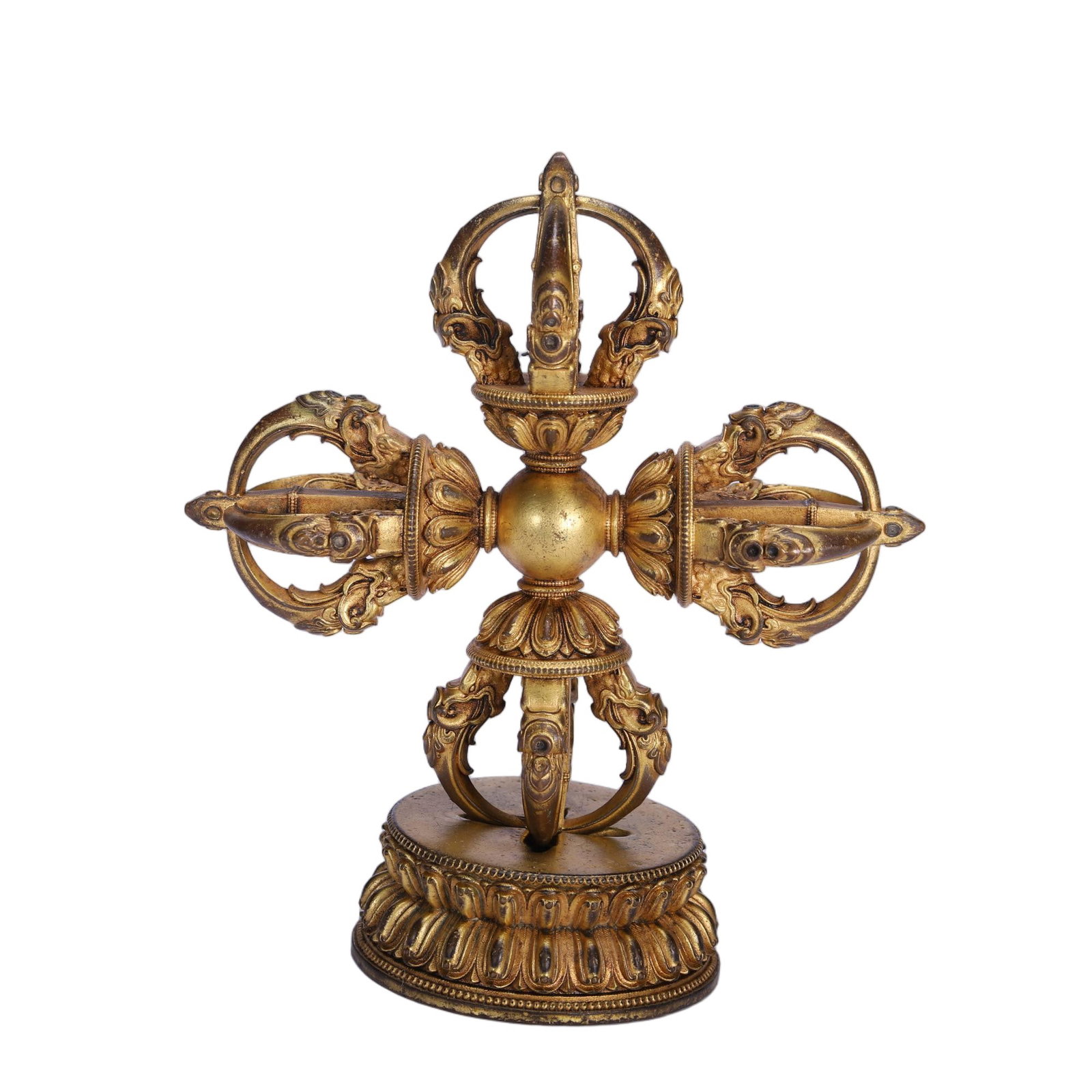A CHINESE GILT BRONZE DOUBLE VAJRA: A CHINESE GILT BRONZE DOUBLE VAJRA This Tibetan Buddhist ritual implement is entirely gilded bronze, crafted as a cross-shaped double vajra with four symmetrical three-pronged heads radiating from a s