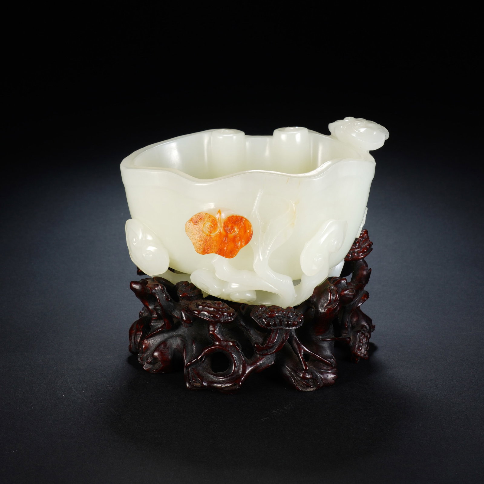 A CHINESE WHITE JADE LINGZHI BRUSH WASHER WITH RUSSET SKIN: A CHINESE WHITE JADE LINGZHI BRUSH WASHER WITH RUSSET SKIN This carved nephrite brush washer measures 12.5cm ? 9cm ? 8cm, with an overall height of 10.5cm including its hardwood stand, and weighs 630 