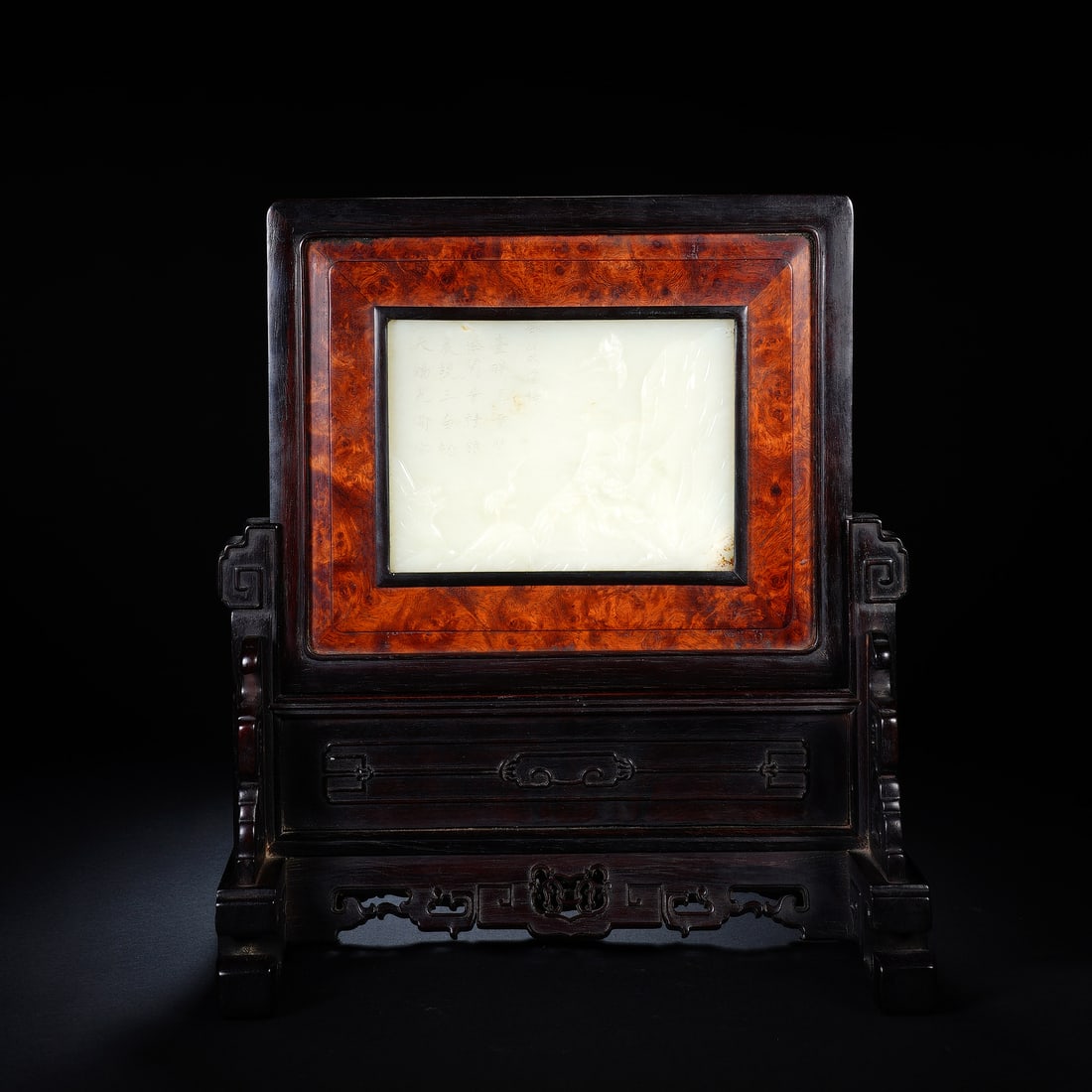 A CHINESE ZITAN TABLE SCREEN WITH WHITE JADE PANEL: A CHINESE ZITAN TABLE SCREEN WITH WHITE JADE PANEL This scholar's table screen is constructed from polished zitan hardwood with a striking burl wood inset border framing a rectangular white nephrite j