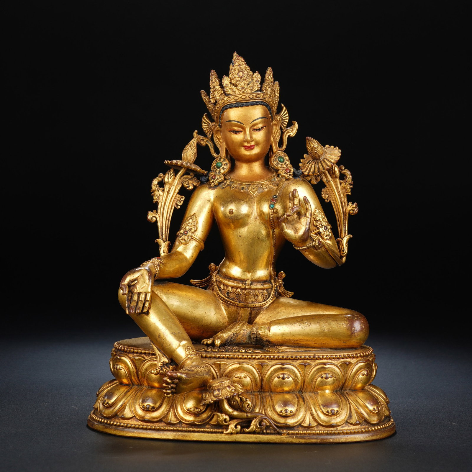 A CHINESE GILT BRONZE SEATED TARA STATUE: A CHINESE GILT BRONZE SEATED TARA STATUE This finely cast gilt bronze Tara figure measures 16cm ? 12cm ? 20cm and weighs 1466 grams. The deity sits in the relaxed lalitasana pose atop a double-layered