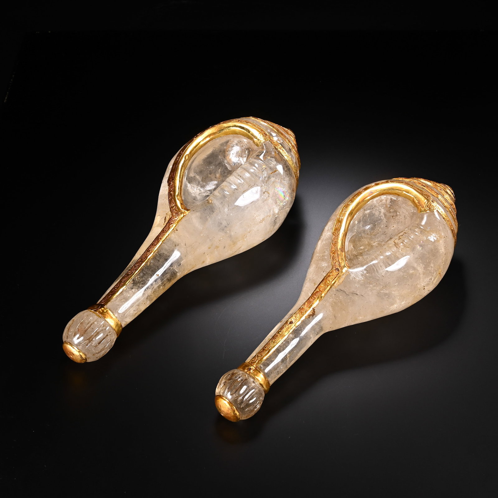 A PAIR OF CHINESE GILDED ROCK CRYSTAL CONCH SHELLS: A PAIR OF CHINESE GILDED ROCK CRYSTAL CONCH SHELLS This matching pair of ritual conches is carved from translucent natural rock crystal, faithfully replicating the spiral shape of sacred Buddhist shel