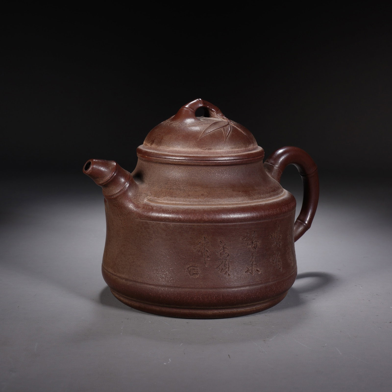 A CHINESE ZISHA CLAY BAMBOO TEAPOT: A CHINESE ZISHA CLAY BAMBOO TEAPOT This hand-thrown zisha clay teapot measures 16 cm wide, 11 cm deep and 11 cm tall, crafted from rich reddish-brown purple sand clay with a smooth matte patina formed