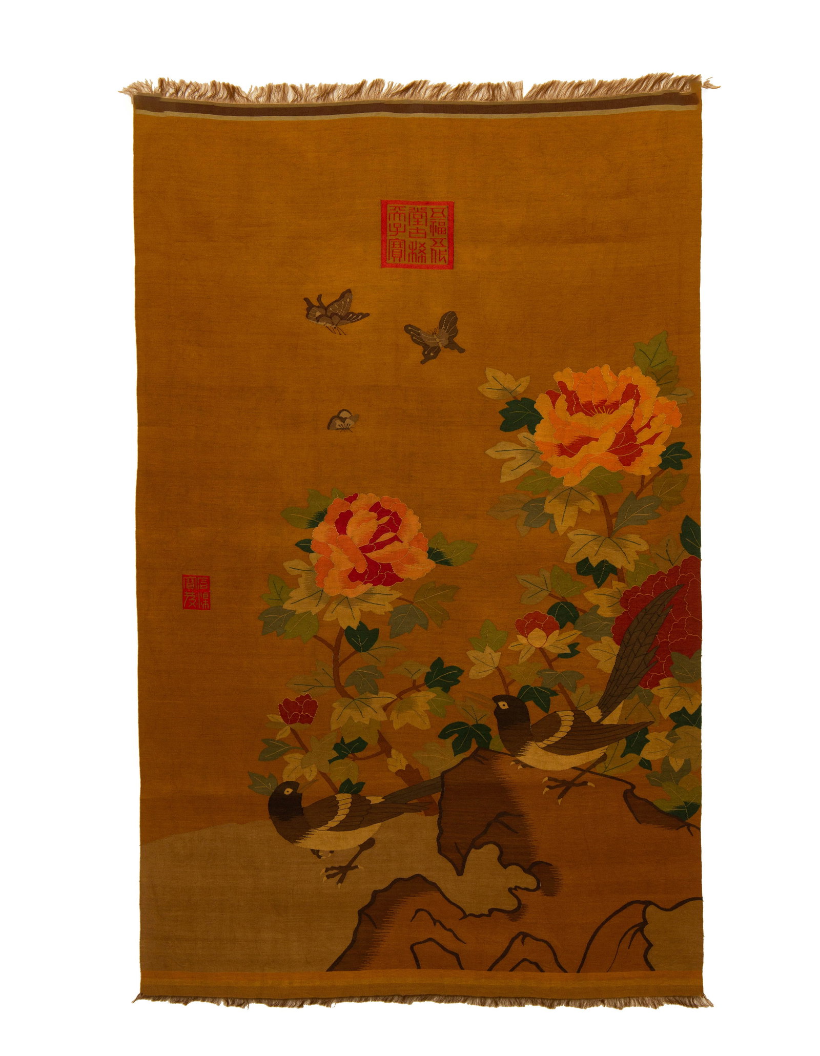 A CHINESE KESI FLOWER AND BIRD PANEL: A CHINESE KESI FLOWER AND BIRD PANEL This exquisite silk kesi tapestry is woven upon a warm amber-yellow textile ground. The vibrant scene features two magpies perched on rugged rock formations amid f