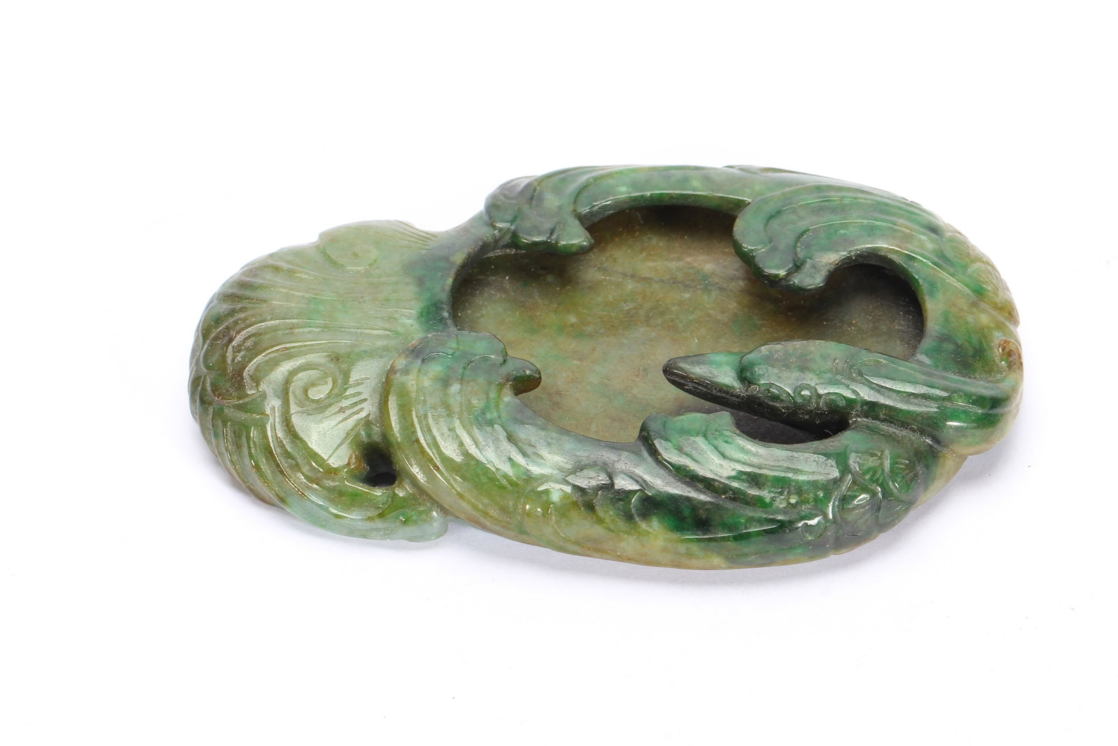 A CHINESE JADEITE PHOENIX WATER WASHER: A CHINESE JADEITE PHOENIX WATER WASHER This scholar's water washer is fully carved from mottled jadeite with mixed apple green, spinach green and pale celadon tones. The vessel is sculpted in the form