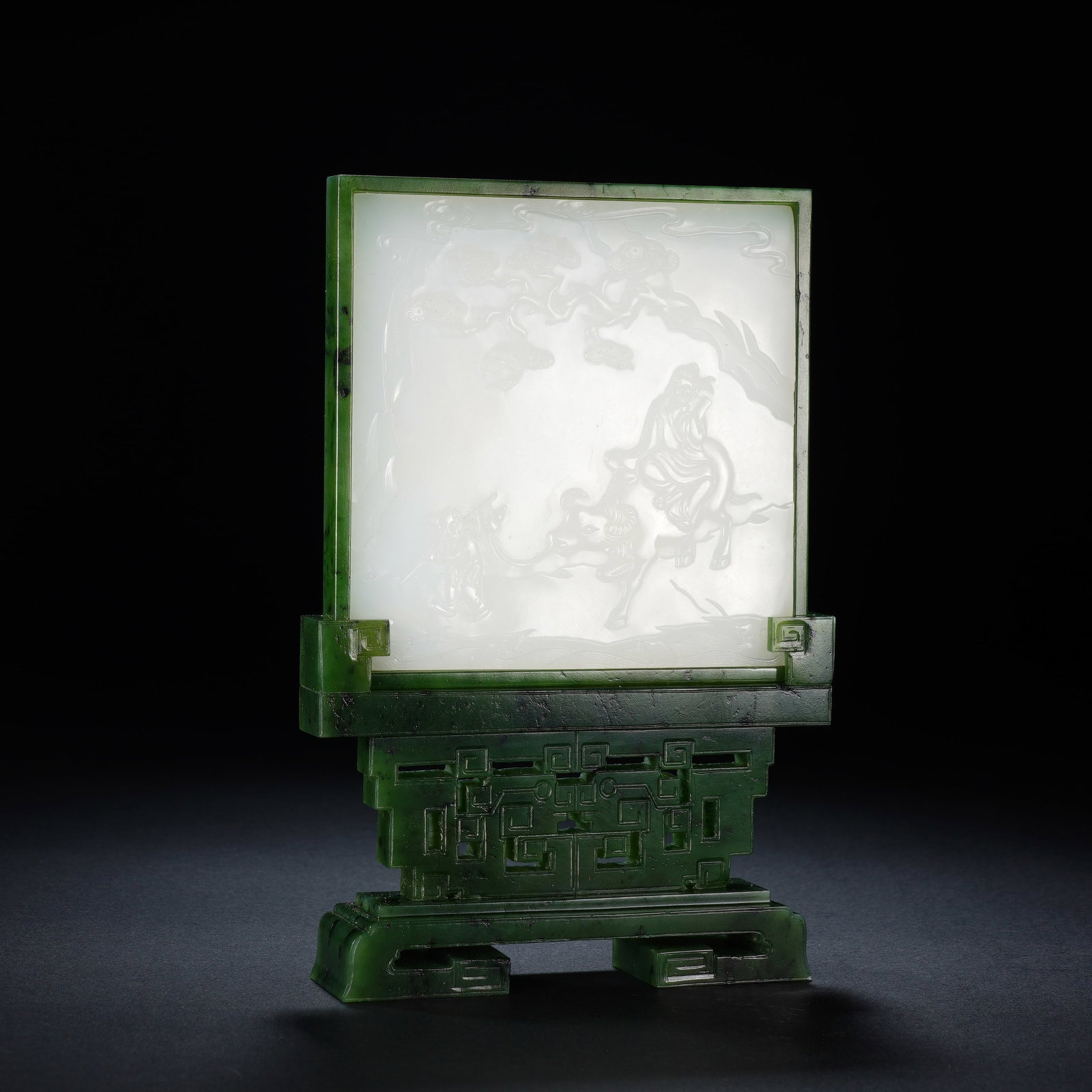 A SPINACH JADE TABLE SCREEN WITH WHITE JADE INLAY: A SPINACH JADE TABLE SCREEN WITH WHITE JADE INLAY This composite jade table screen measures 10.7 cm wide, 2.7 cm deep and 15.5 cm tall, weighing 355 grams. The frame and integral stand are carved from