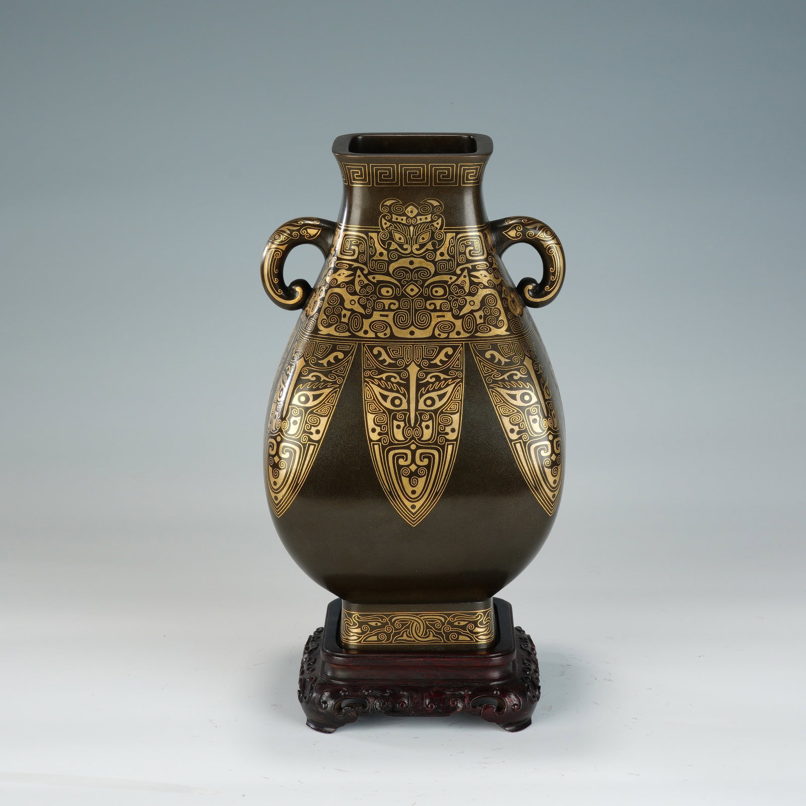 A CHINESE BRONZE GOLD & SILVER INLAID TWIN-EARED ZUN VASE: A CHINESE BRONZE GOLD & SILVER INLAID TWIN-EARED ZUN VASE This archaistic bronze zun vessel measures 15cm ? 15cm ? 27cm with an overall height of 31cm and weighs 2712 grams. It features two scroll-sha