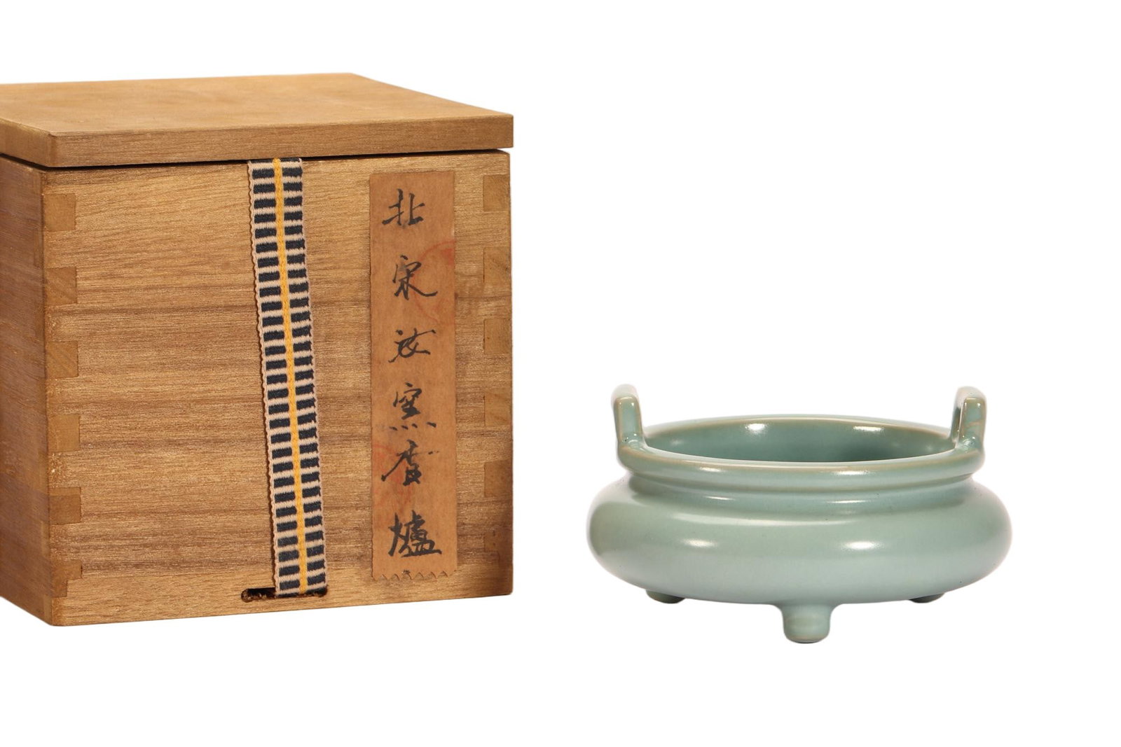 A CHINESE RU-TYPE CELADON TRIPOD CENSER: A CHINESE RU-TYPE CELADON TRIPOD CENSER This tripod censer is entirely covered in smooth, uniform pale celadon glaze with a subtle soft gloss characteristic of classic Ru wares. It features a compress