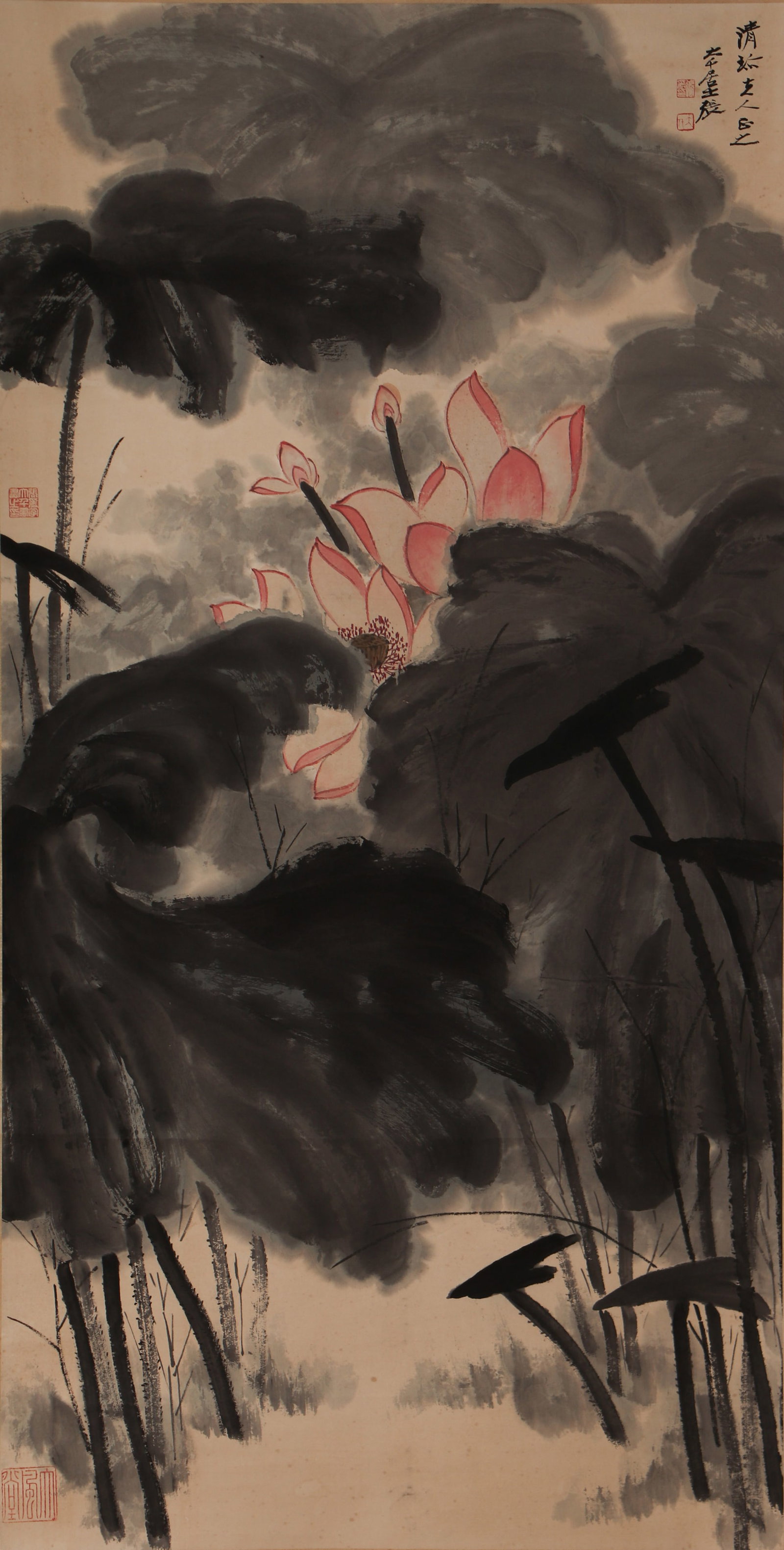 A CHINESE PAINTING OF RED LOTUS, SIGNED ZHANG DAQIAN: A CHINESE PAINTING OF RED LOTUS, SIGNED ZHANG DAQIAN Vertical ink and colour lotus painting on aged rice paper, inscribed, titled and sealed by Zhang Daqian in the upper right. Large lotus leaves are 