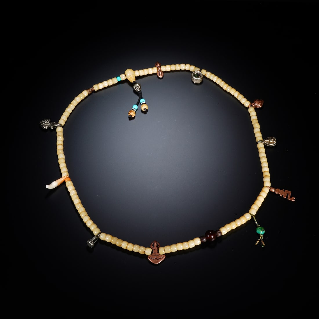 A CHINESE BONE TIBETAN RITUAL MALA BEADS: A CHINESE BONE TIBETAN RITUAL MALA BEADS This devotional Tibetan counting mala is strung with uniform flat disc-shaped carved bone beads, each 0.8 cm in diameter, presenting a warm creamy aged patina 