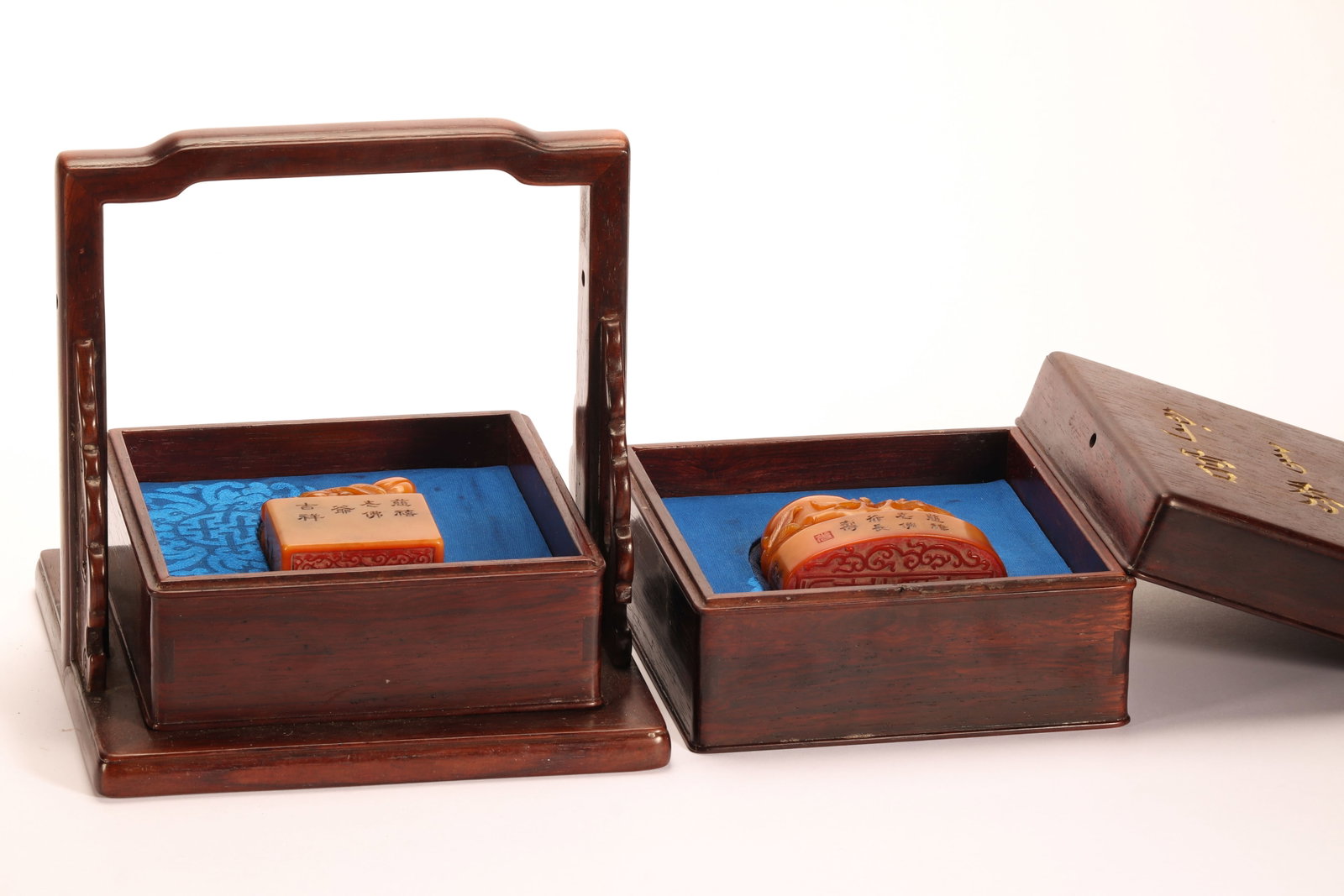 A PAIR OF CHINESE TIANHUANG STONE SEALS: A PAIR OF CHINESE TIANHUANG STONE SEALS This matching pair of literati seals is carved from warm honey-toned Tianhuang soapstone, each topped with finely sculpted mythical beast finials. One rectangul