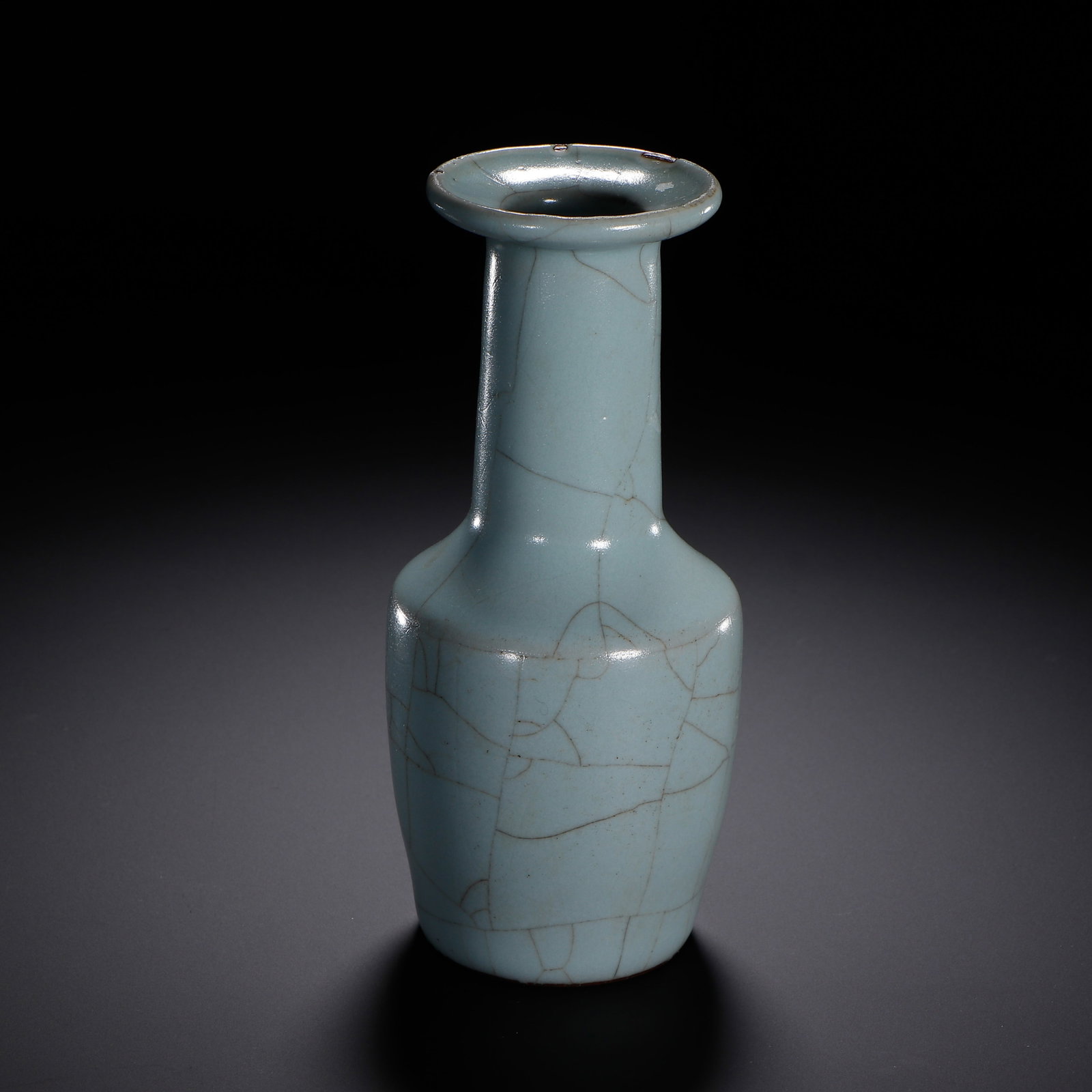 A CHINESE GUAN CRACKLE GLAZE VASE: A CHINESE GUAN CRACKLE GLAZE VASE This elegant mallet-form vase is entirely coated in soft pale sky-blue Guan glaze, covered with a natural network of fine dark crackle veins across the smooth lustrou