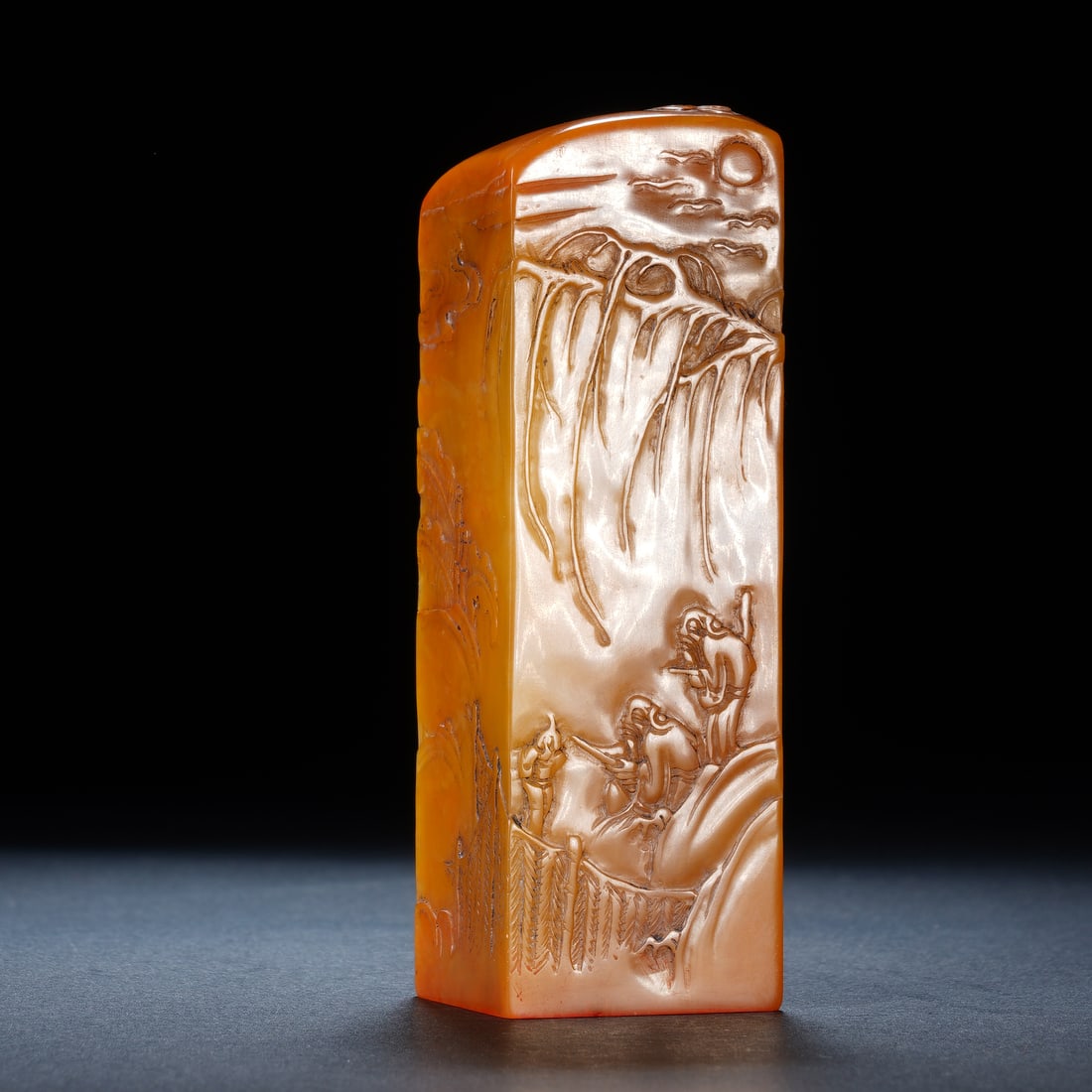 A CHINESE TIANHUANG STONE LANDSCAPE SEAL: A CHINESE TIANHUANG STONE LANDSCAPE SEAL Carved from premium natural tianhuang stone with warm honey-orange translucent tone, this square seal is adorned with masterful thin relief bo yi carving cover