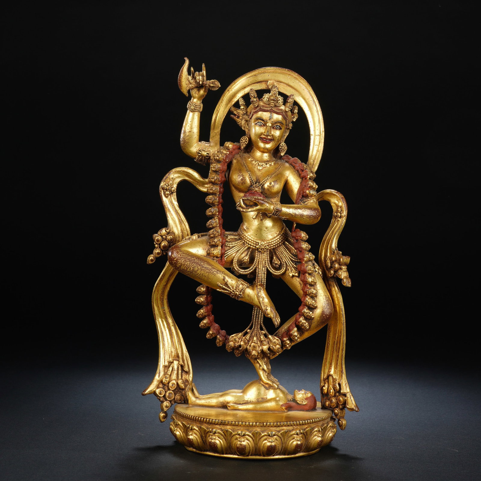 A CHINESE GILT BRONZE VAJRAVARAHI STATUE: A CHINESE GILT BRONZE VAJRAVARAHI STATUE This elaborate gilt bronze Vajravarahi figure measures 14.5cm ? 11cm ? 26cm and weighs 2151 grams. The deity stands in dynamic dancing posture atop a supine hu