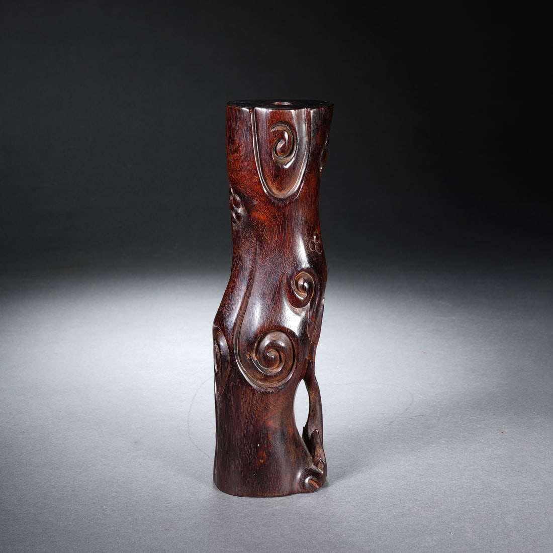A CHINESE ZITAN LINGZHI FORM FLOWER VASE: A CHINESE ZITAN LINGZHI FORM FLOWER VASE Carved from dense polished zitan hardwood, this naturalistic flower holder is modelled after a twisting gnarled tree trunk adorned with flowing raised lingzhi 