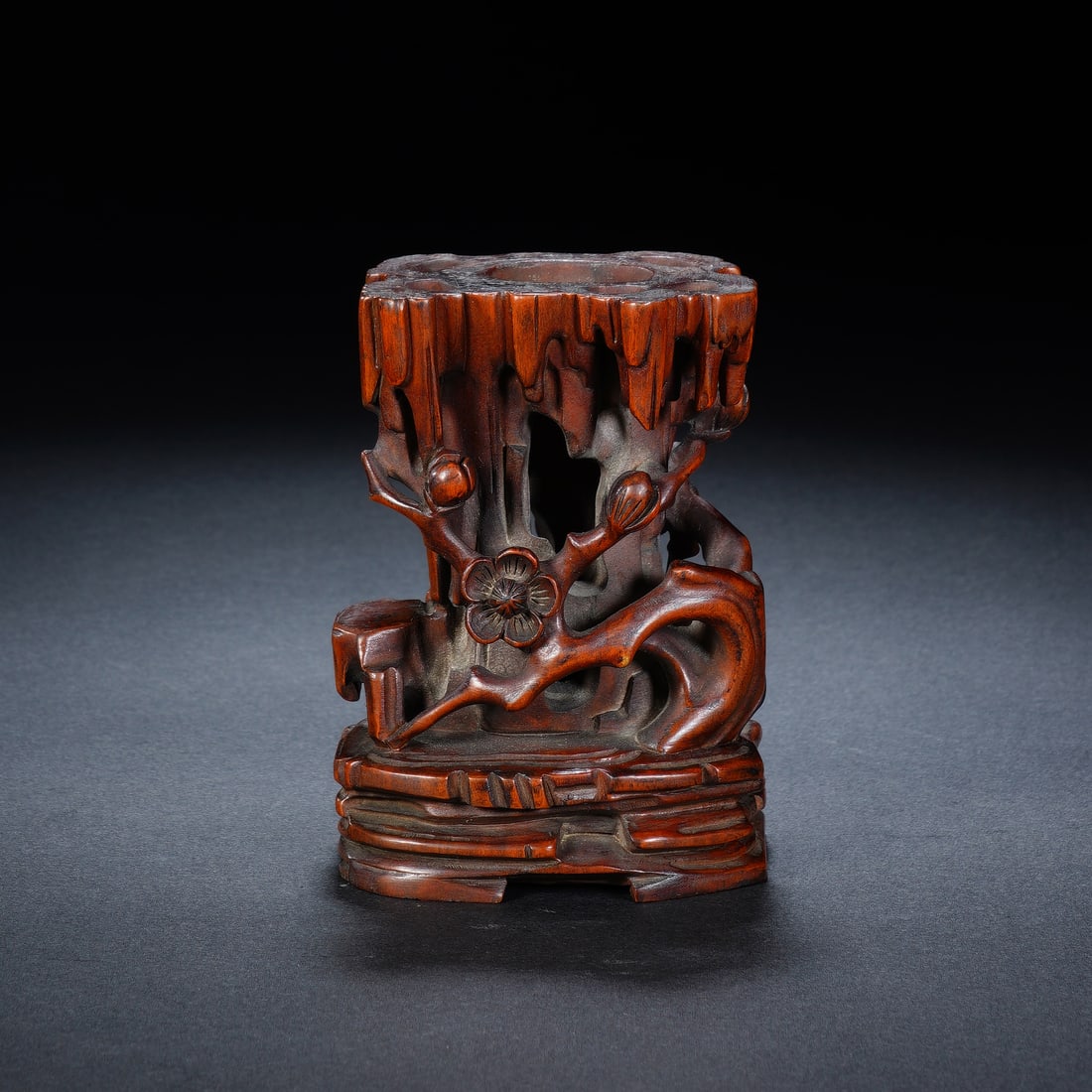 A CHINESE BOXWOOD PRUNUS BLOSSOM VASE STAND: A CHINESE BOXWOOD PRUNUS BLOSSOM VASE STAND This miniature carved boxwood flower holder measures 6.5cm ? 5cm ? 9cm, sculpted to mimic a weathered hollow tree trunk with jagged dripping bark textures a