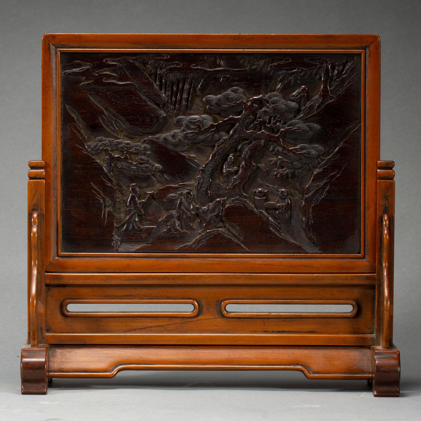 A CHINESE HUANGHUALI INLAID ZITAN TABLE SCREEN: A CHINESE HUANGHUALI INLAID ZITAN TABLE SCREEN A fine table screen framed in smooth huanghuali wood with warm amber patina, inset with a rectangular carved zitan panel of deep rich tone. The hardwood 