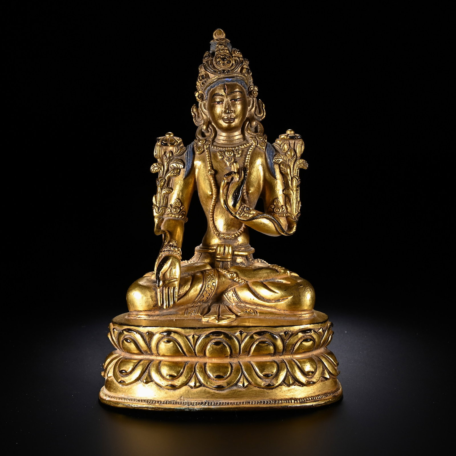 A CHINESE GILT COPPER BODHISATTVA STATUE: A CHINESE GILT COPPER BODHISATTVA STATUE This finely cast Buddhist figure is executed in gilt copper with a lustrous golden finish. The bodhisattva sits in full lotus position atop a double-lotus pede