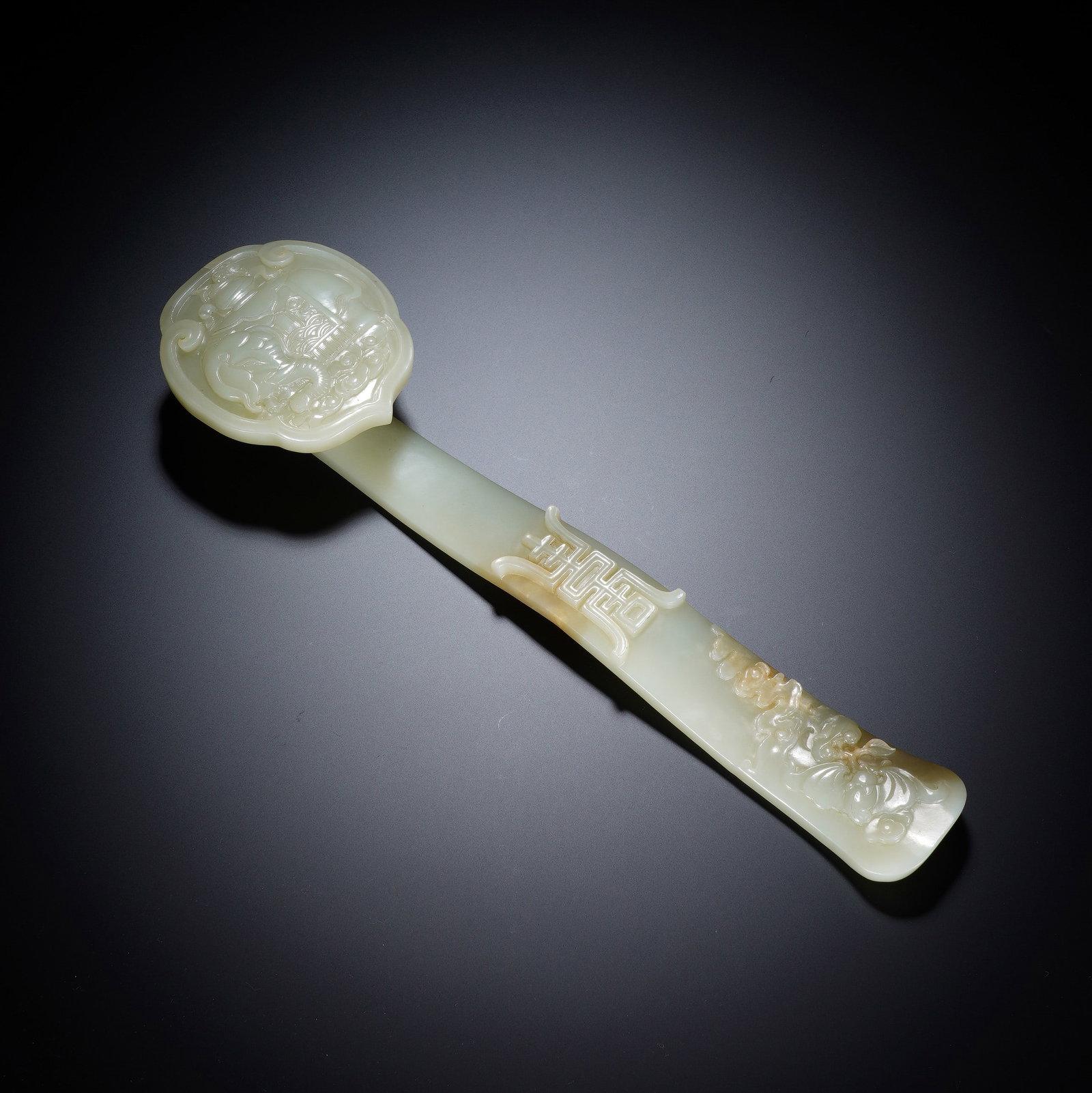 A CHINESE WHITE JADE RUYI SCEPTER WITH AUSPICIOUS ELEPHANT MOTIF: A CHINESE WHITE JADE RUYI SCEPTER WITH AUSPICIOUS ELEPHANT MOTIF This elegant nephrite jade ruyi scepter measures 27 cm in length and weighs 292 grams, carved from smooth pale white jade with subtle n