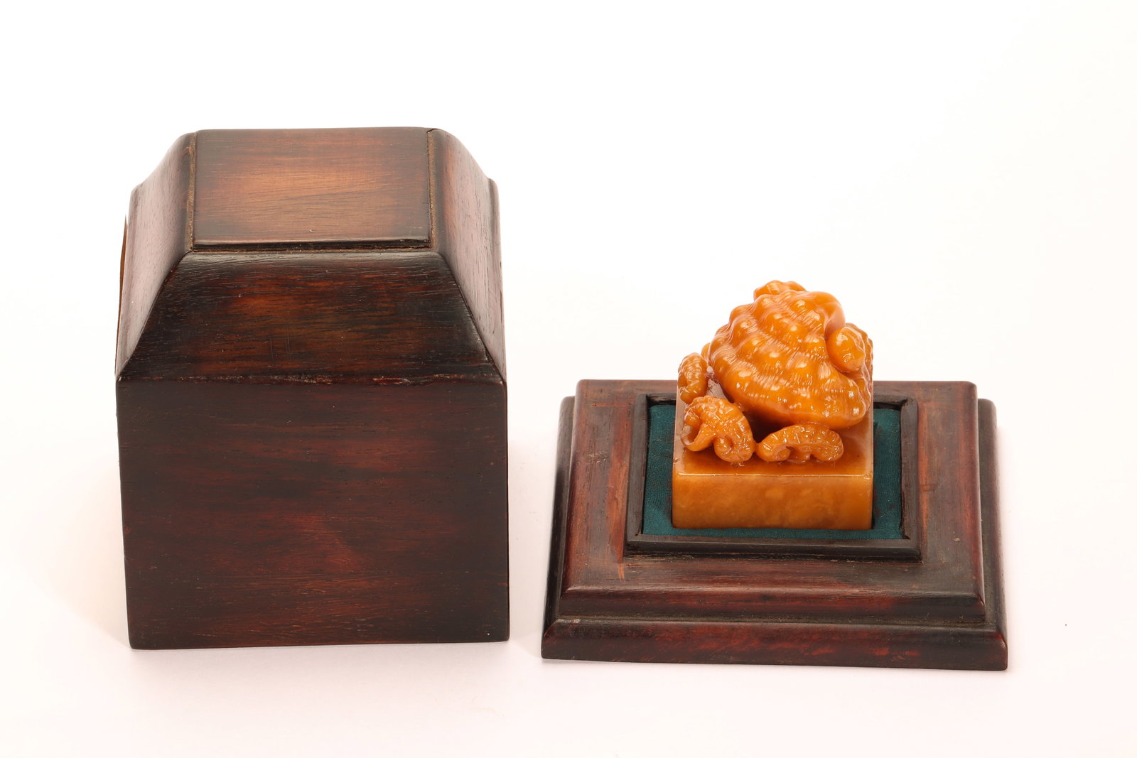 A CHINESE TIANHUANG STONE FINGER CITRON SEAL: A CHINESE TIANHUANG STONE FINGER CITRON SEAL This square scholar's seal is carved from lustrous warm golden Tianhuang stone, surmounted by a finely detailed finger citron finial with textured segmente