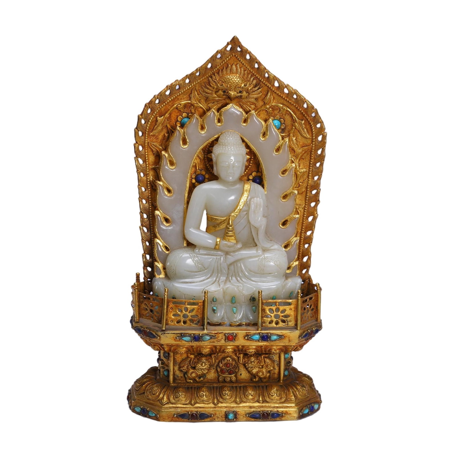 A CHINESE GILT BRONZE MOUNTED JADE BUDDHA SHRINE: A CHINESE GILT BRONZE MOUNTED JADE BUDDHA SHRINE A devotional ensemble centering a seated Buddha carved from smooth pale Hetian nephrite jade with soft waxy luster. The Buddha sits in full lotus postu