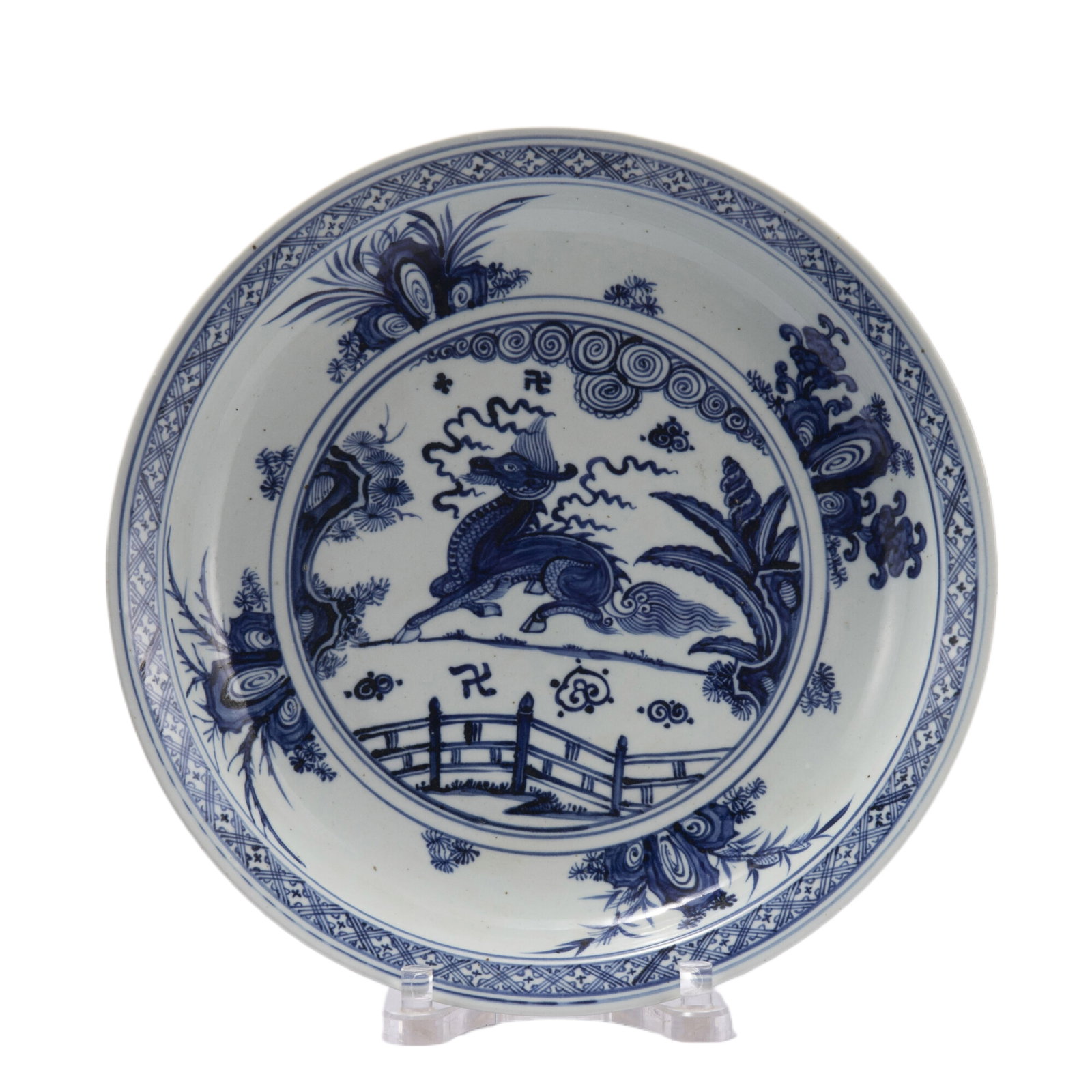 A BLUE AND WHITE PORCELAIN DISH: A BLUE AND WHITE PORCELAIN DISH The interior decorated with mythical beast kylin in garden, encircled with an evenly spaced rocks band. DIMENSIONS: L. 42.8 cm. H. 7.5 cm. HAVE A SIMILAR ITEM TO SELL? 