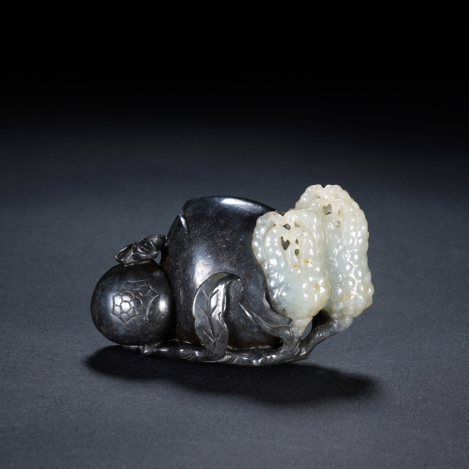 A CHINESE BLACK AND WHITE JADE BRUSH REST: A CHINESE BLACK AND WHITE JADE BRUSH REST This carved jade brush rest measures 7 cm long, 2.8 cm wide and 4.5 cm tall, weighing 99 grams. Crafted from natural black-and-white nephrite seed material, i