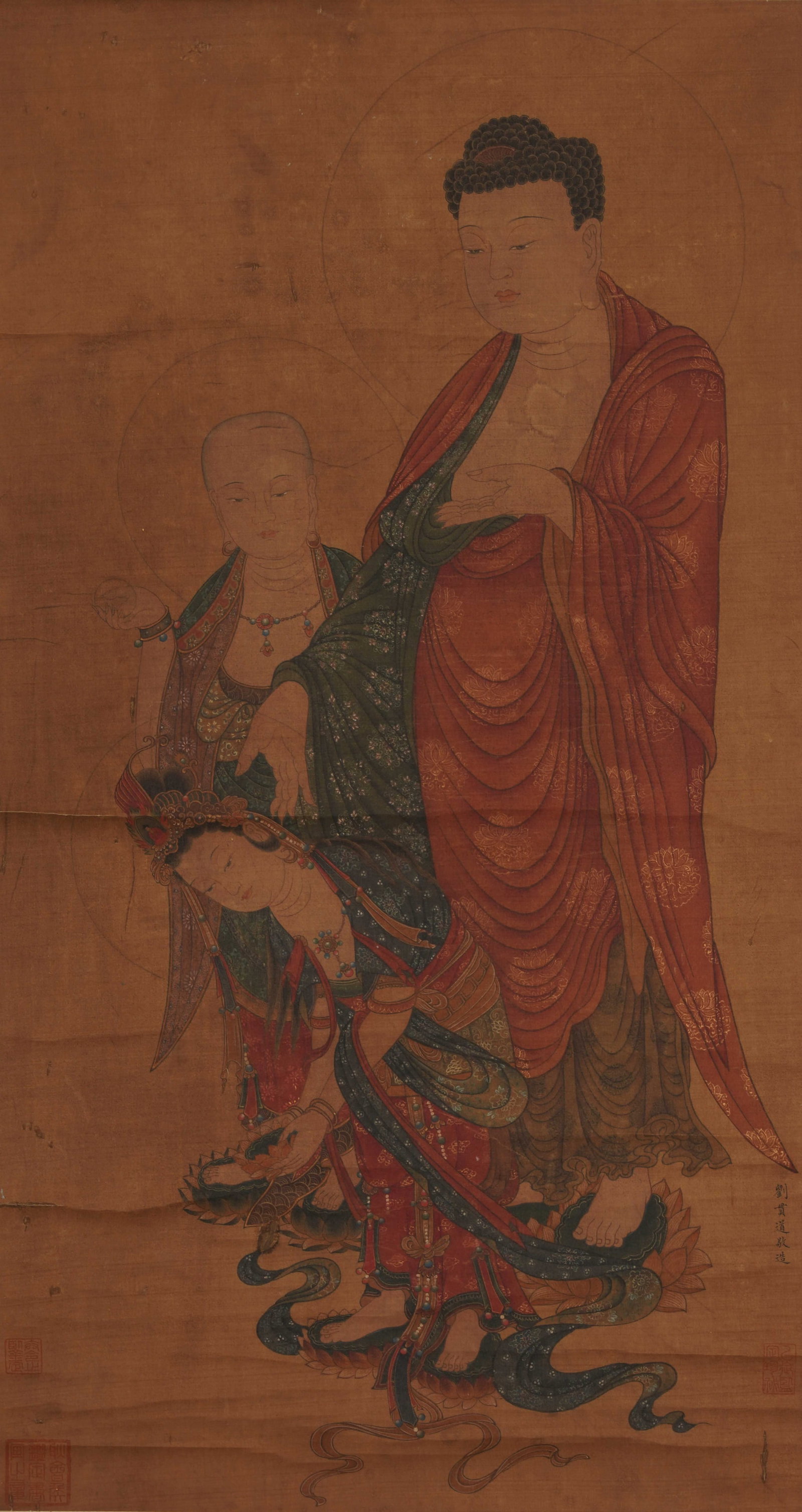 A CHINESE PAINTING OF BUDDHA AND ATTENDANTS, SIGNED LIU GUANDAO: A CHINESE PAINTING OF BUDDHA AND ATTENDANTS, SIGNED LIU GUANDAO Vertical mineral colour Buddhist painting on aged amber silk, signed by Liu Guandao at the right edge. The sacred composition features a