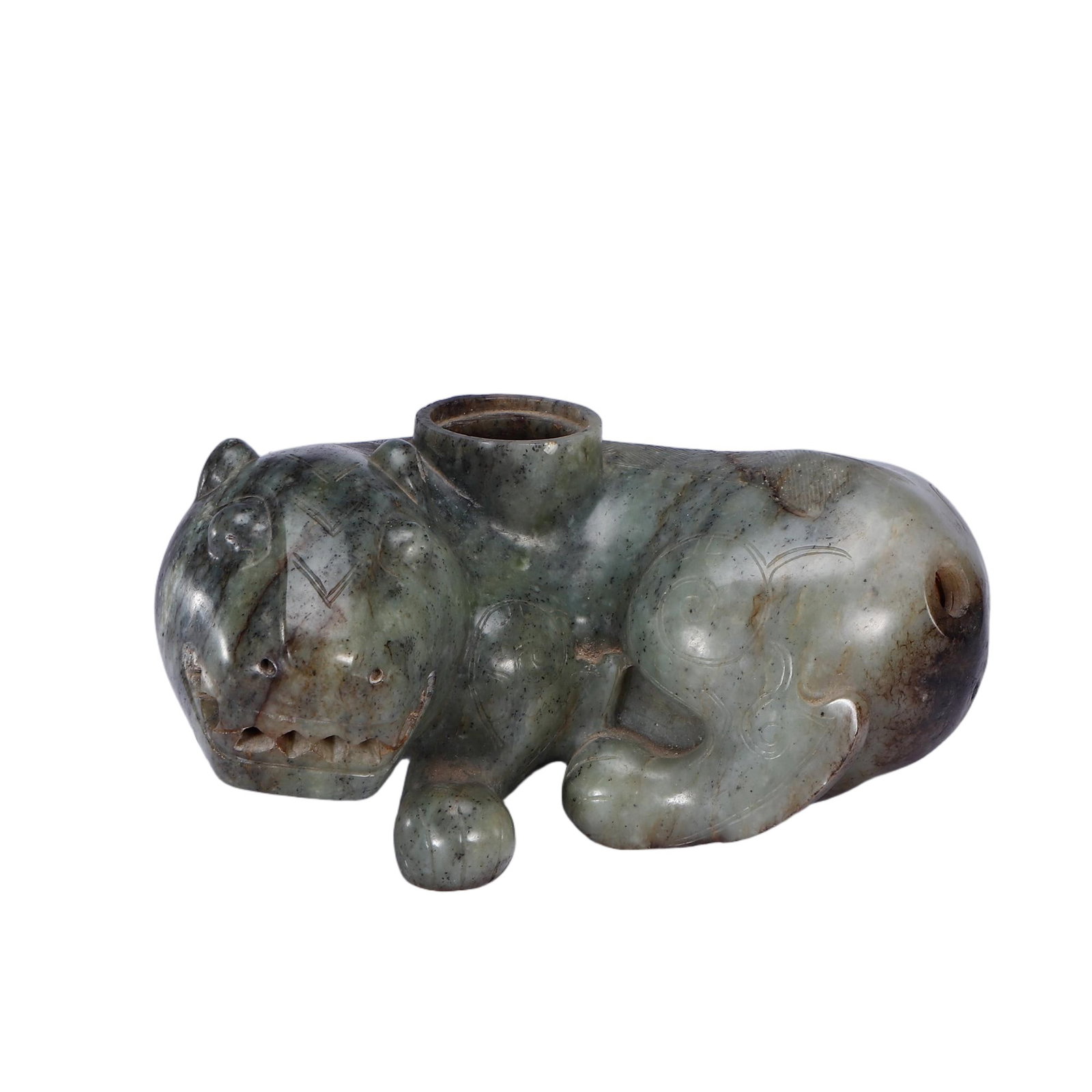 A CHINESE HETIAN JADE MYTHICAL BEAST VESSEL: A CHINESE HETIAN JADE MYTHICAL BEAST VESSEL This hollow ritual vessel is carved from mottled greyish-green Hetian nephrite permeated with natural dark mineral speckles and russet aged patina. It takes