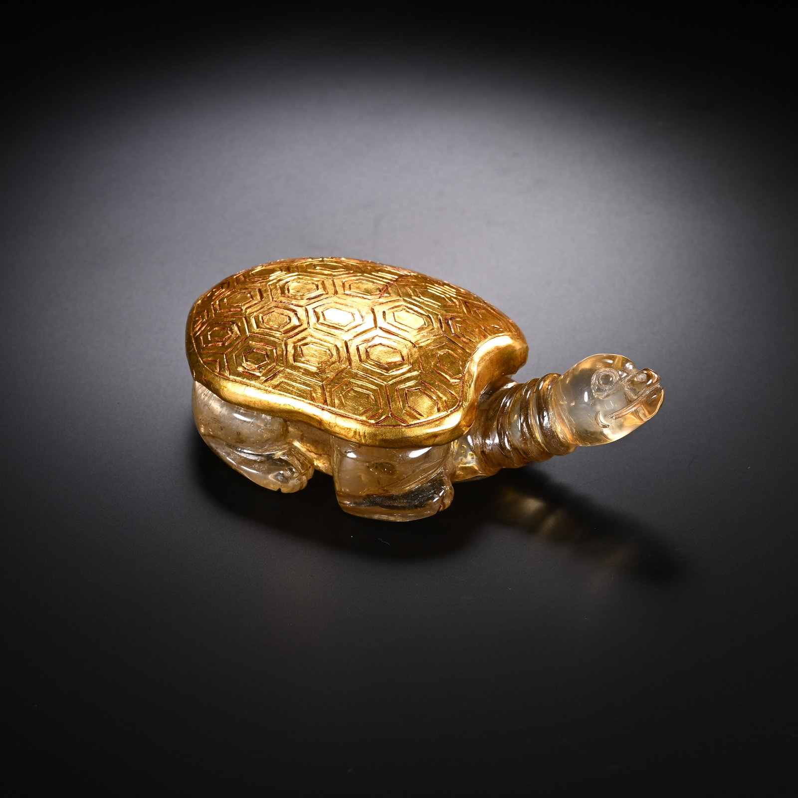 A CHINESE GILDED CRYSTAL TURTLE ORNAMENT: A CHINESE GILDED CRYSTAL TURTLE ORNAMENT Skillfully carved from transparent rock crystal, this auspicious turtle figure features clear polished crystal forming its head, neck and limbs with fine natur