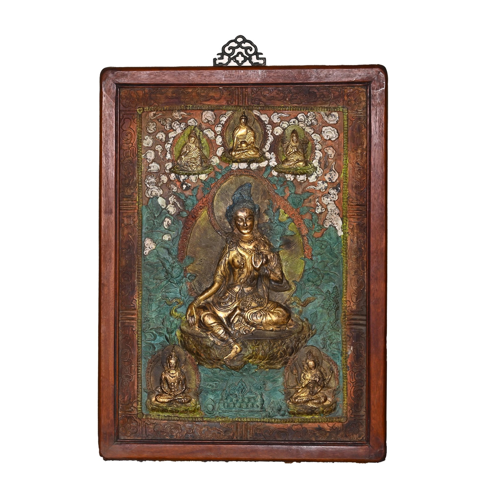 A CHINESE GILT COPPER REPOUSS? THANGKA PANEL IN HARDWOOD FRAME: A CHINESE GILT COPPER REPOUSSE THANGKA PANEL IN HARDWOOD FRAME This wall-mounted devotional panel features a central repousse gilt bronze figure of Green Tara seated in the relaxed royal ease pose ato