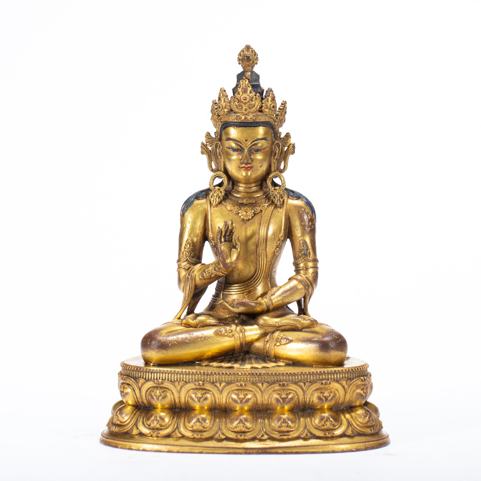 A CHINESE GILT BRONZE BUDDHA FIGURE: A CHINESE GILT BRONZE BUDDHA FIGURE This finely cast copper alloy Buddha is entirely gilded, seated in full lotus meditation atop a double-lotus pedestal moulded with neatly layered floral buds. The d