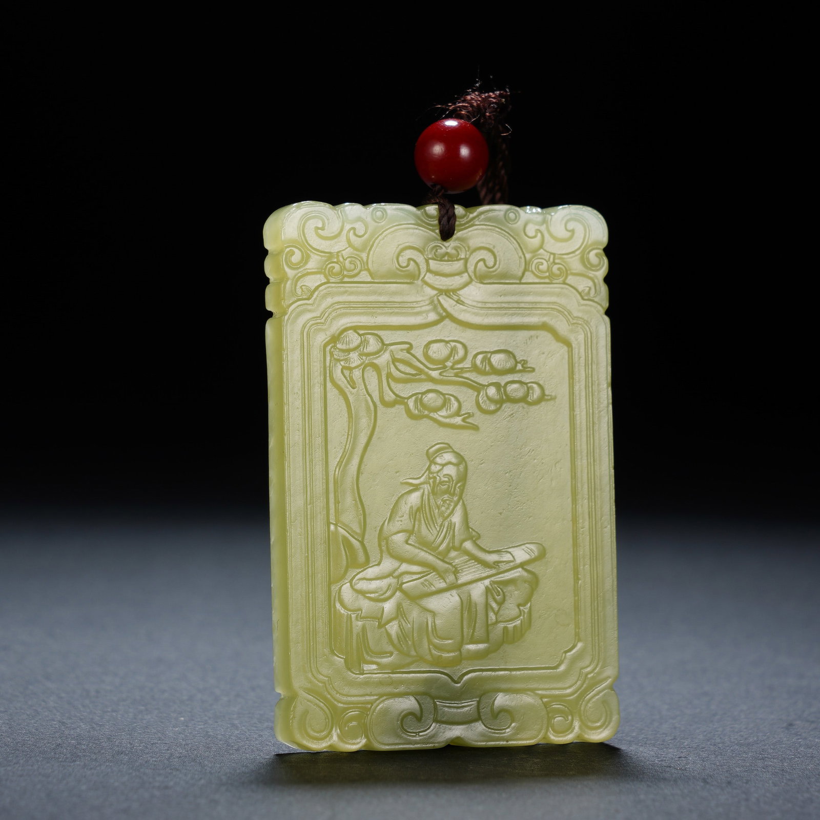 A CHINESE YELLOW NEPHRITE SCHOLAR PLAQUE: A CHINESE YELLOW NEPHRITE SCHOLAR PLAQUE This rectangular yellow nephrite plaque measures 4 cm wide, 6 cm tall and 0.5 cm thick, weighing 32 grams. The warm pale yellow stone is polished to a soft gen
