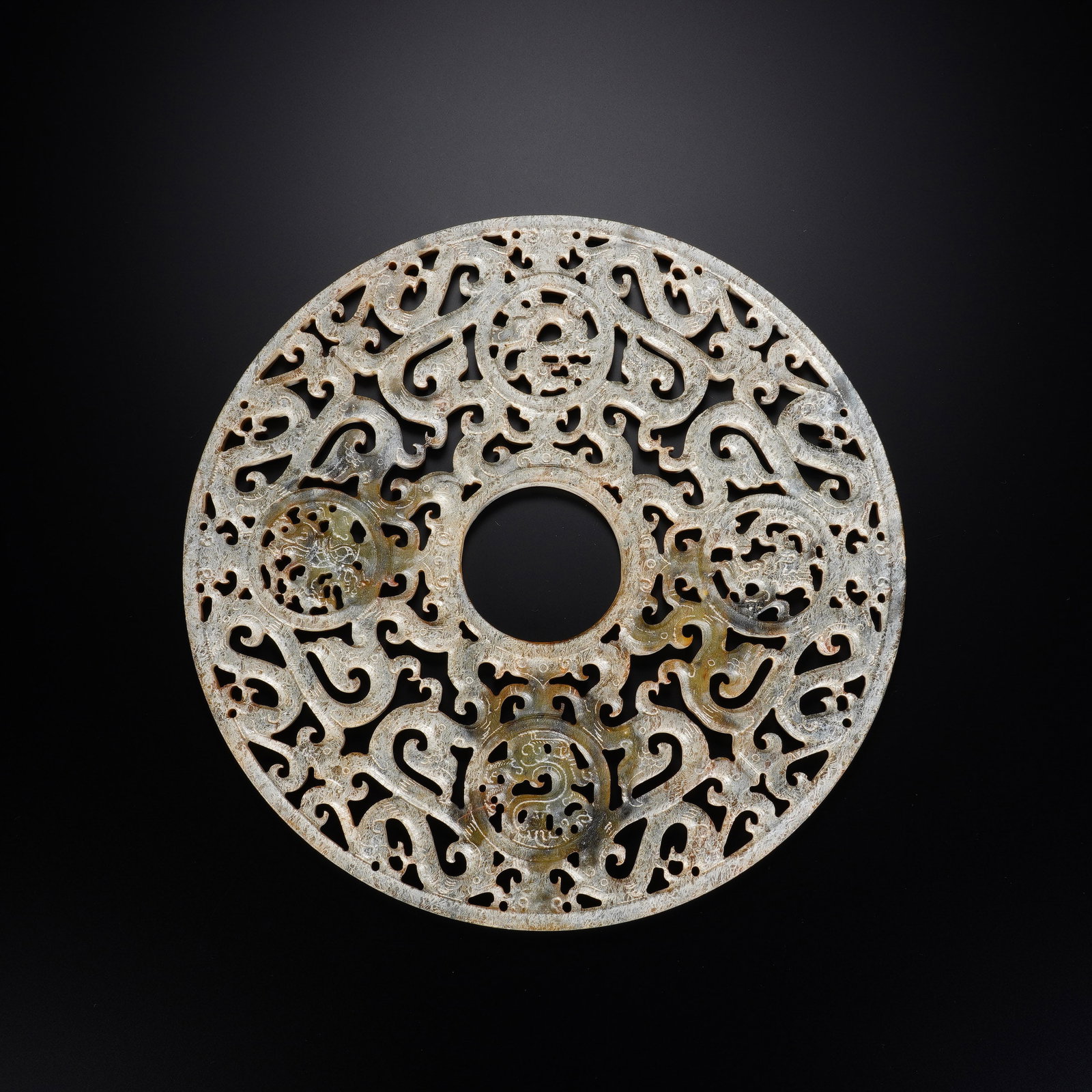 A CHINESE OPENWORK ARCHAIC JADE BI DISC (1 of 8)