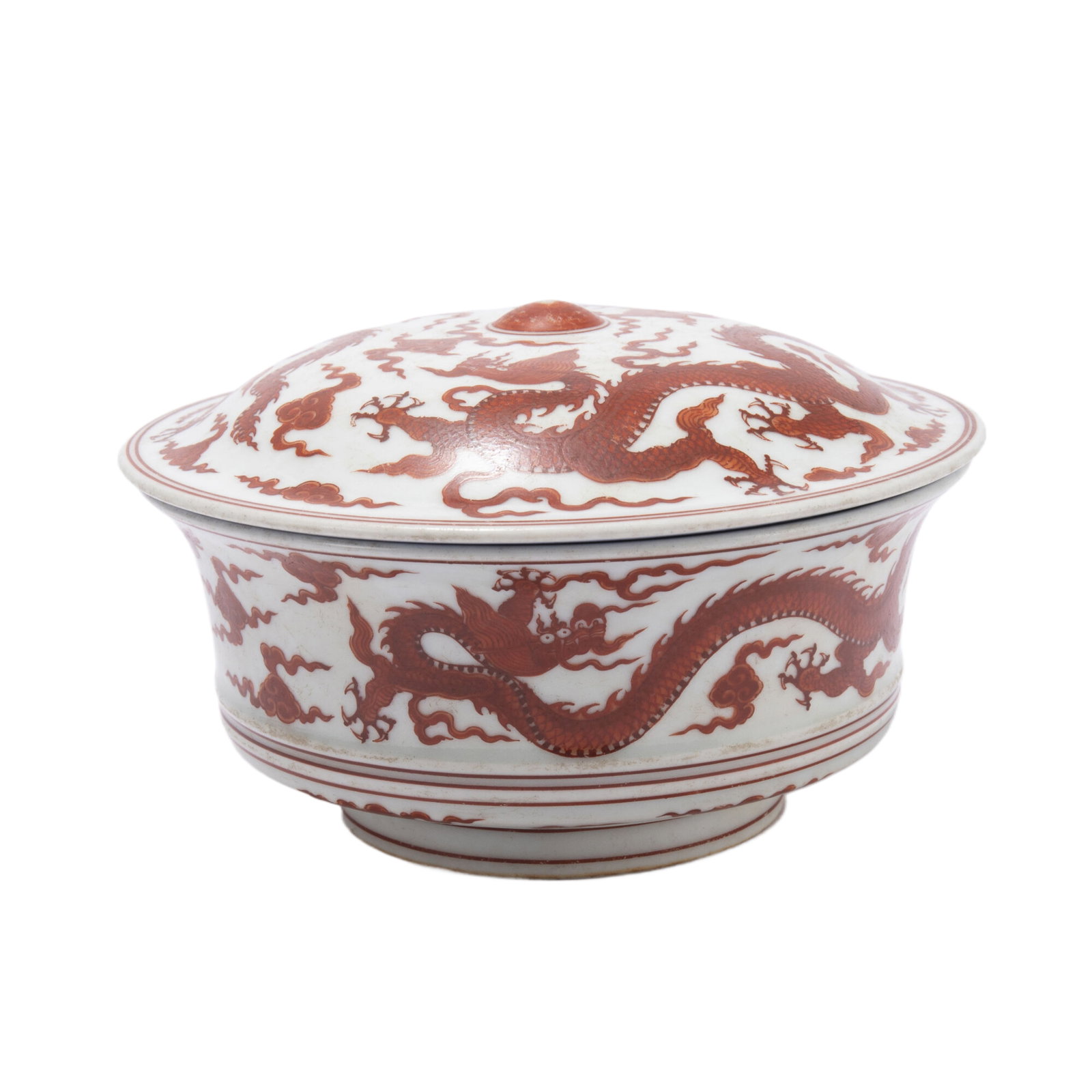 AN IRON RED GLAZE PORCELAIN DRAGON LIDDED BOWL,XUANDE: AN IRON RED GLAZE PORCELAIN DRAGON LIDDED BOWL,XUANDE The deep rounded sides rising from a slightly tapered foot to an everted rim, the exterior painted in pale ground, with dragon in iron red, Xuande