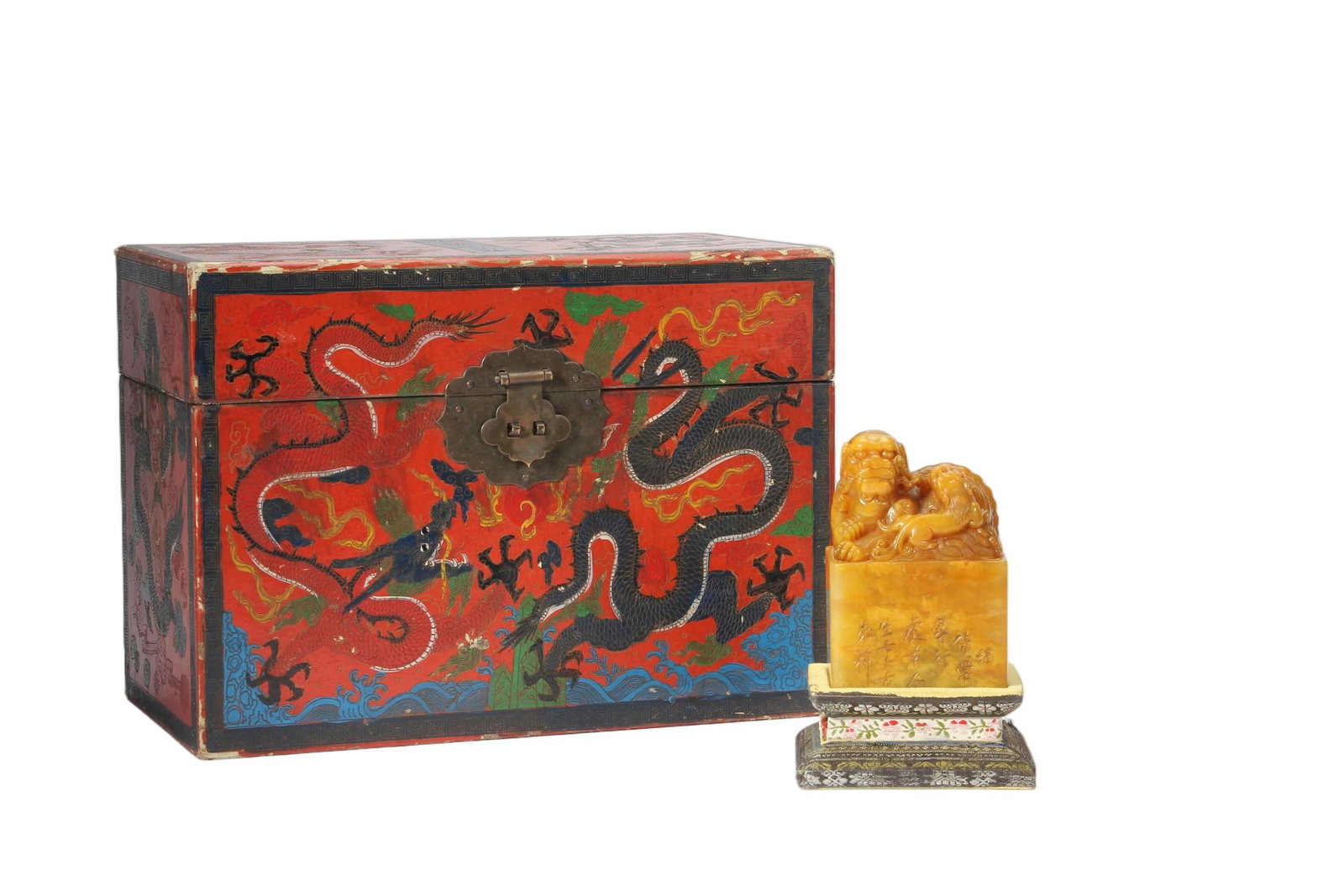 A CHINESE TIANHUANG STONE LION SEAL WITH LACQUER DRAGON BOX: A CHINESE TIANHUANG STONE LION SEAL WITH LACQUER DRAGON BOX This substantial square seal is carved from rich golden honey-toned Tianhuang stone with subtle natural veining throughout the matrix. Its f